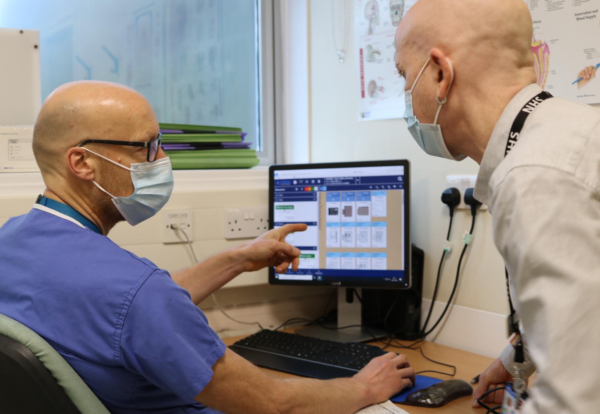 nhs staff looking at computer screen