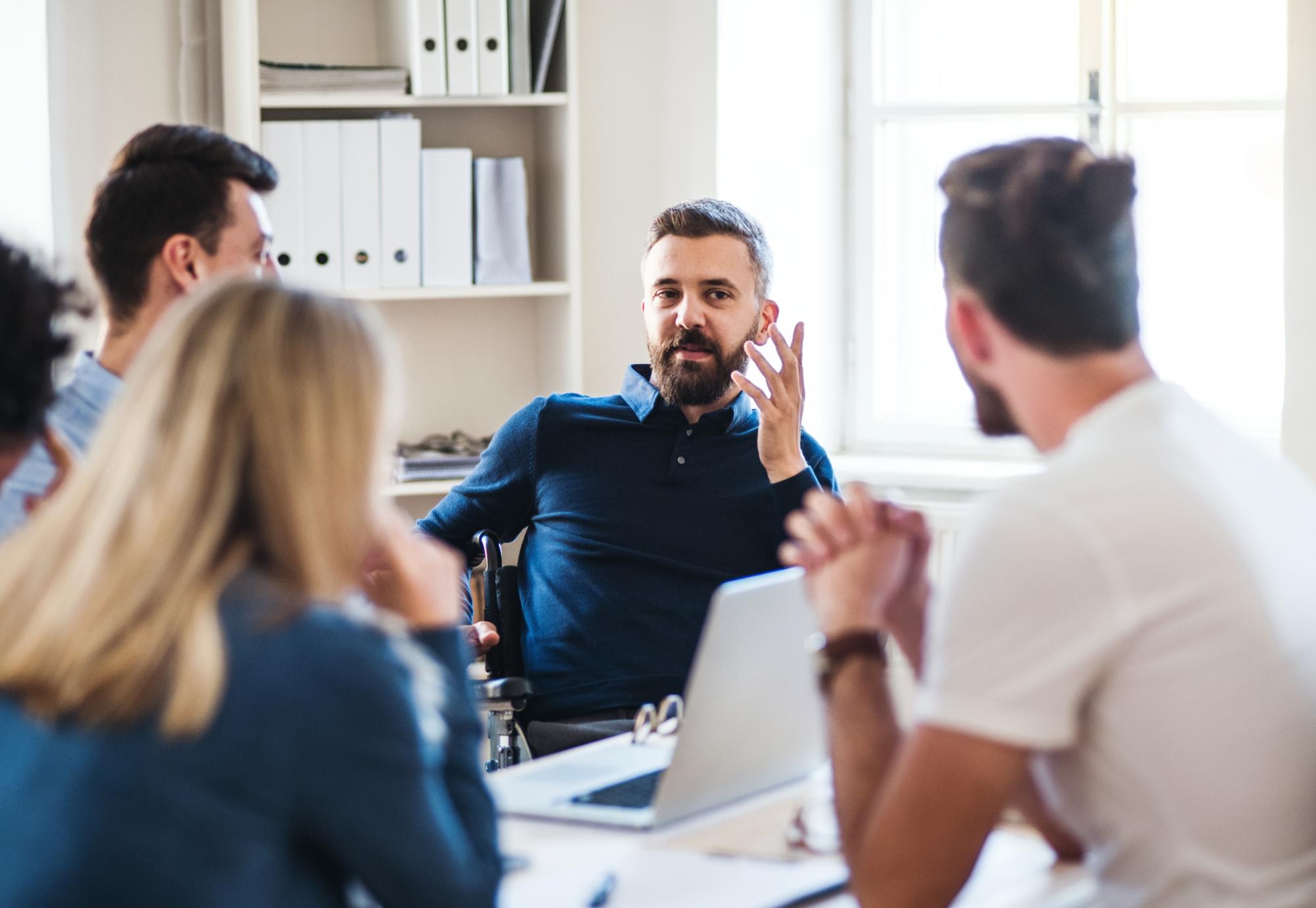 Man discussing in a meeting with colleagues