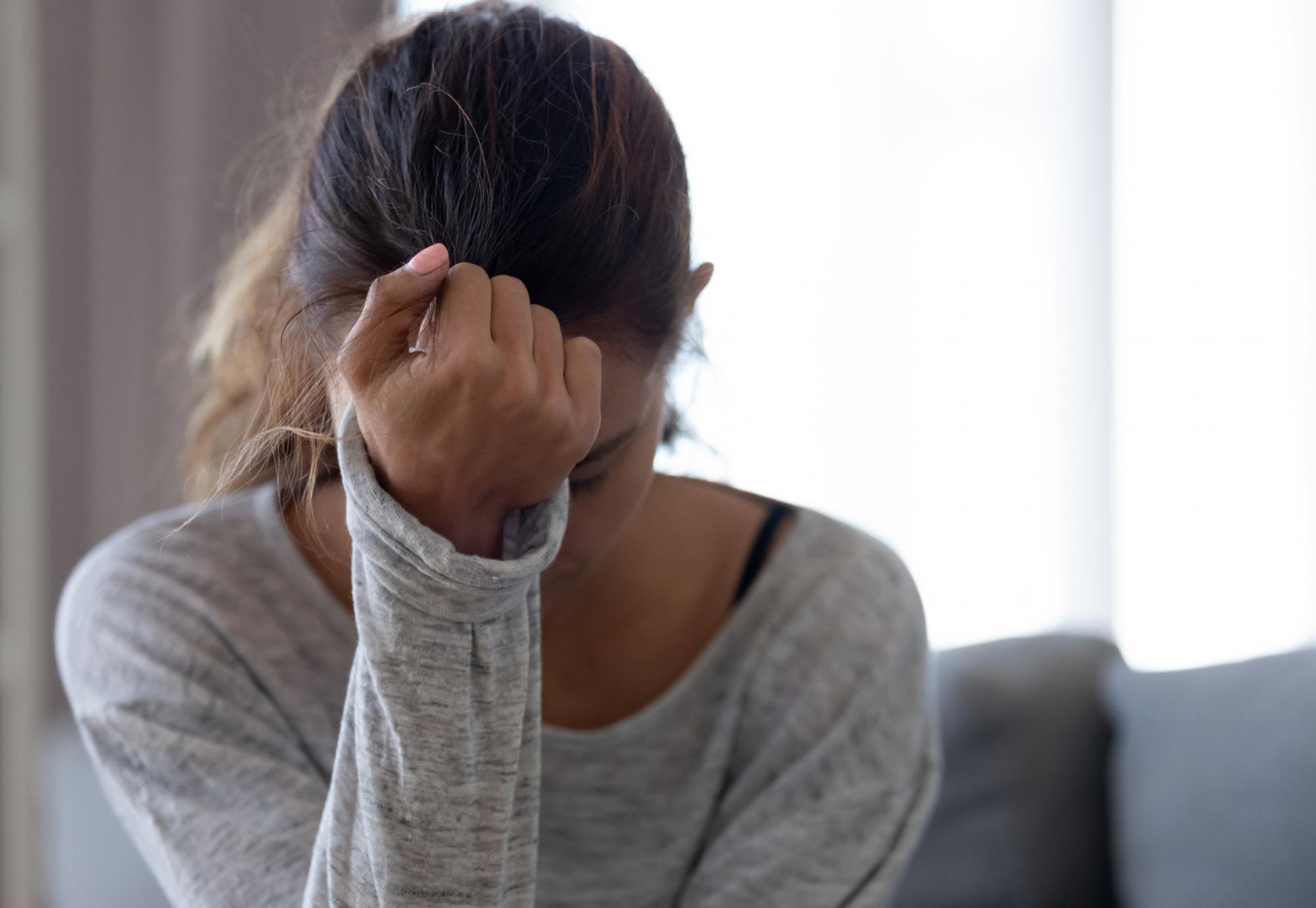 woman with head in hands