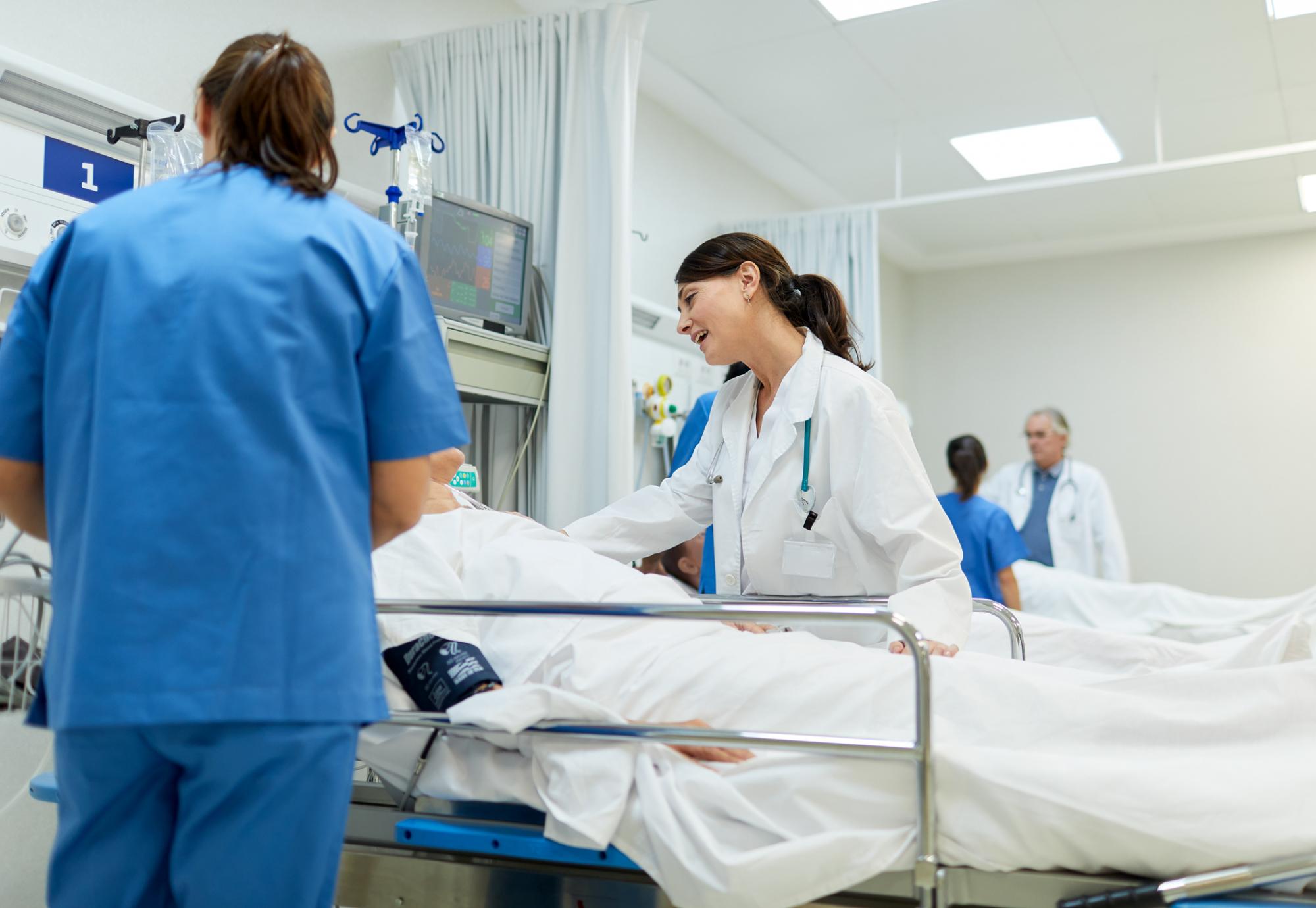 Doctor speaking to a patient in a hospital bed