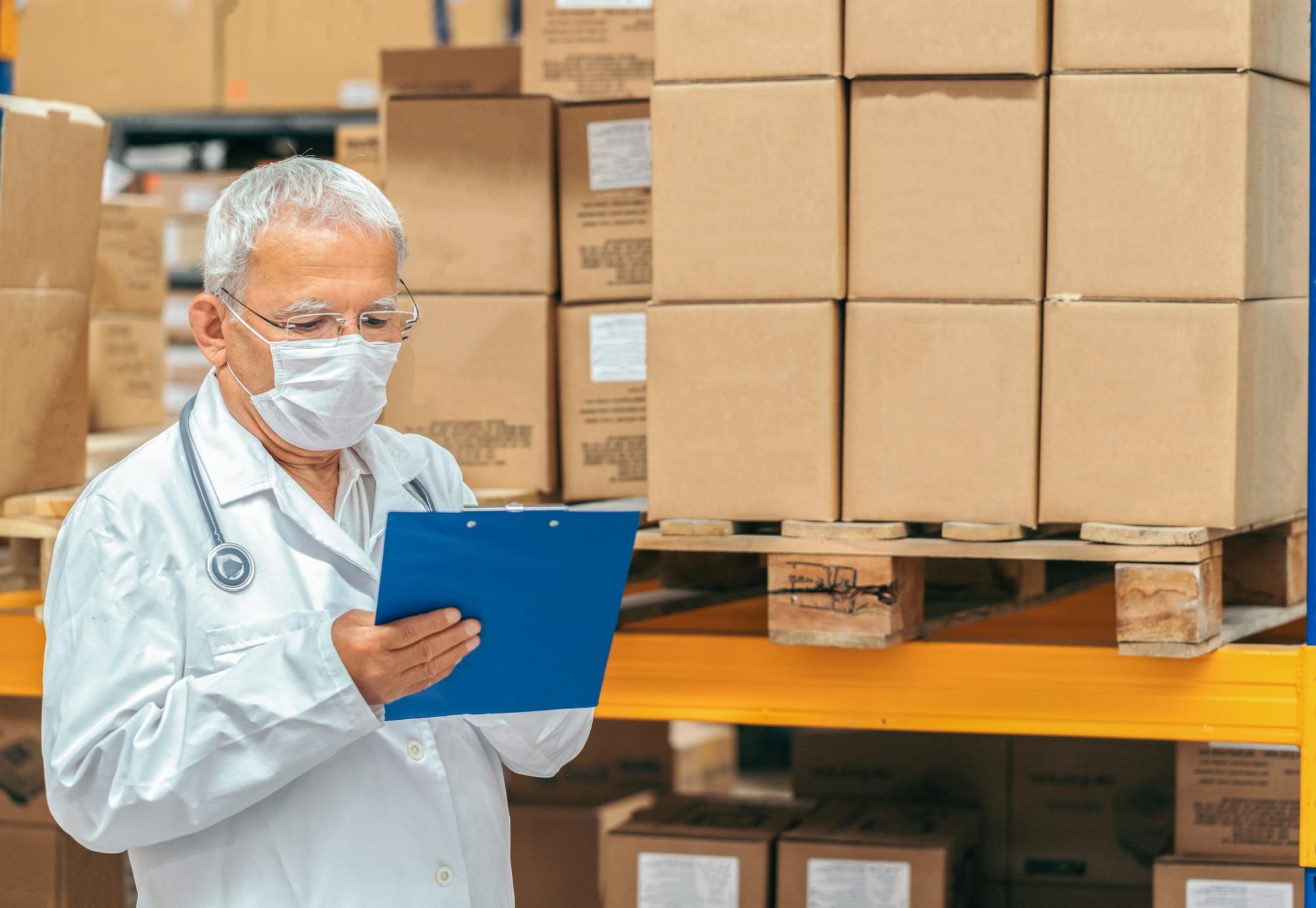 Health professional checking supplies in a warehouse