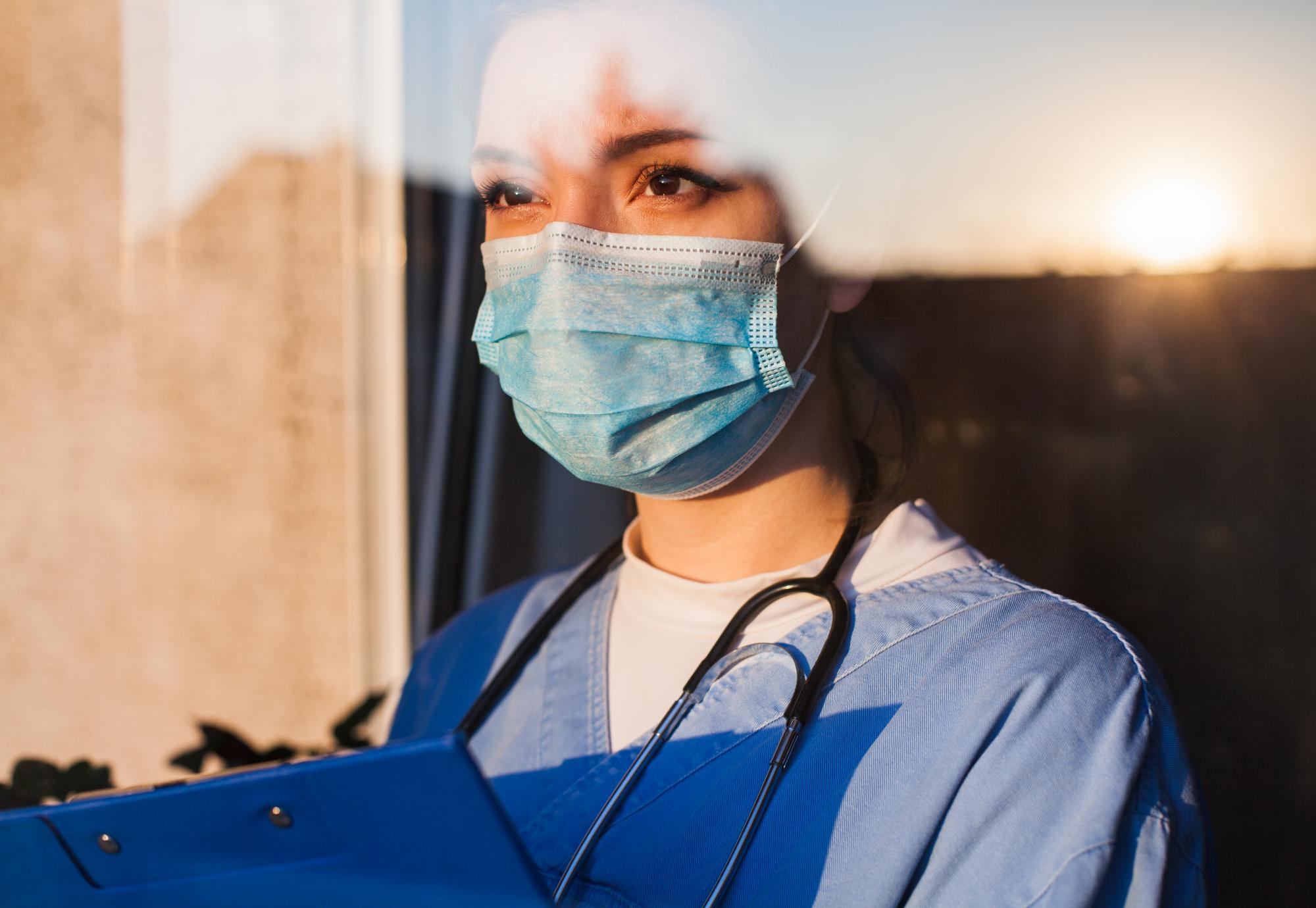 nurse looking out of window 