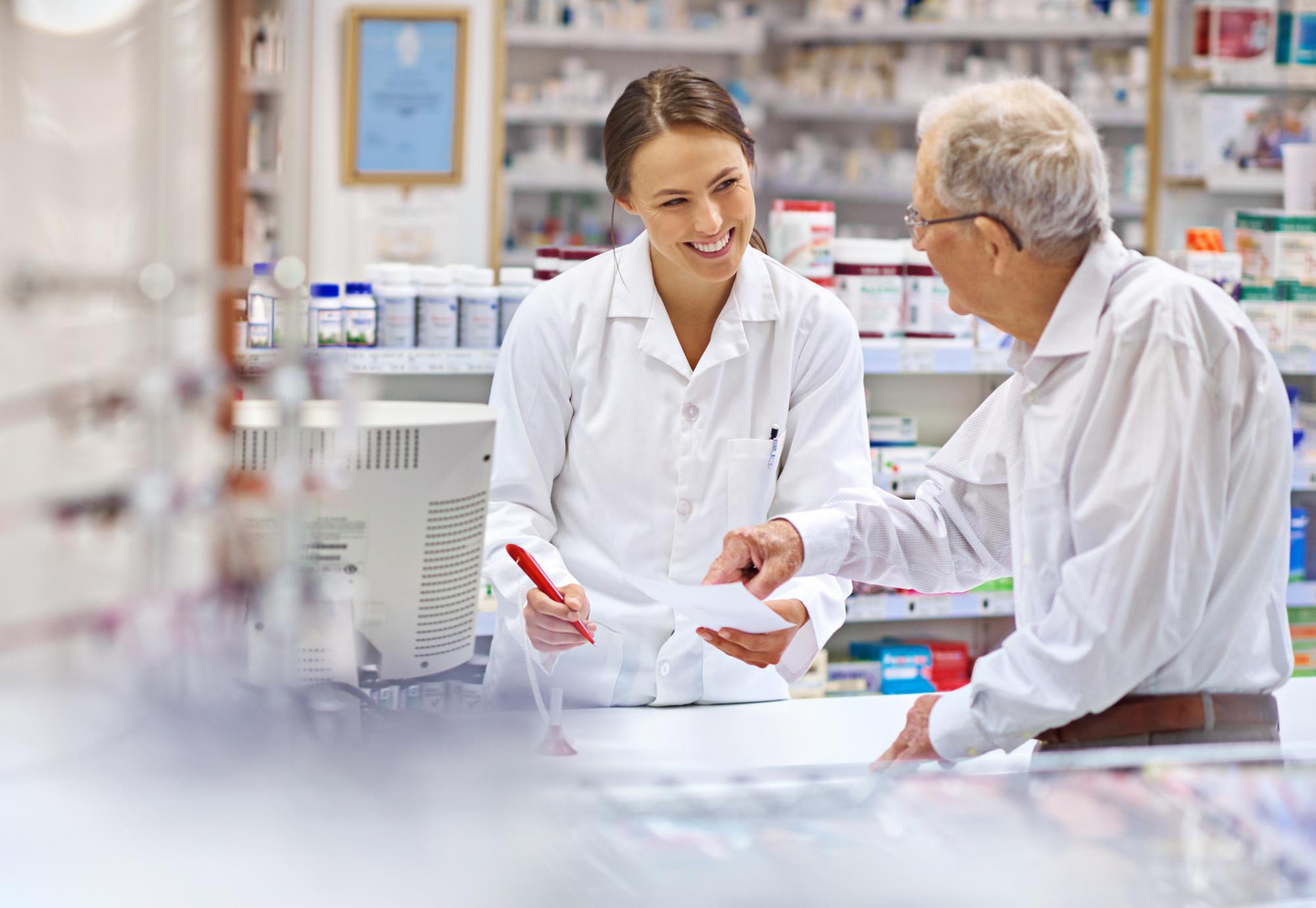 Pharmacist helping an elderly man