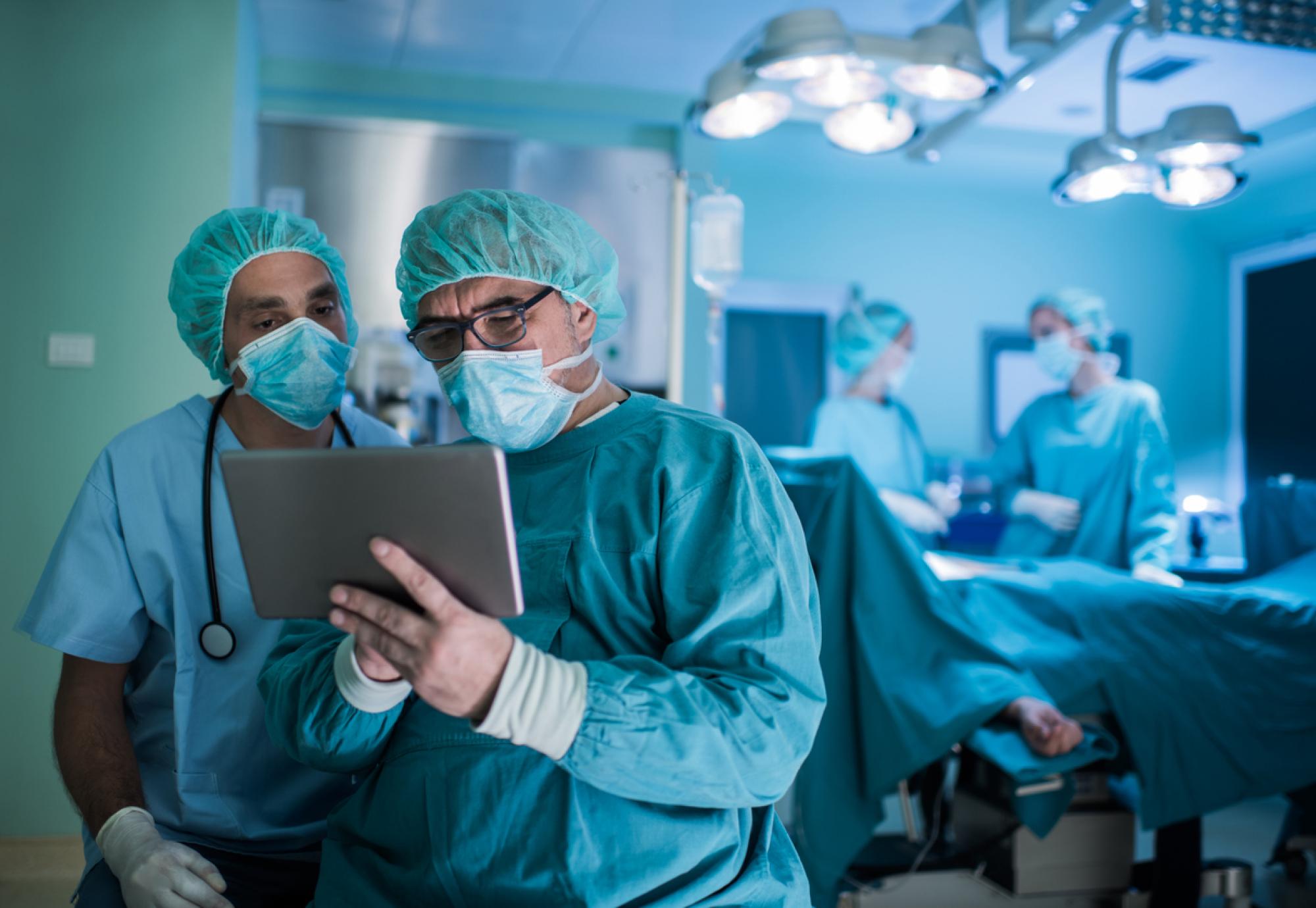 two surgeons using tablet in theatre 