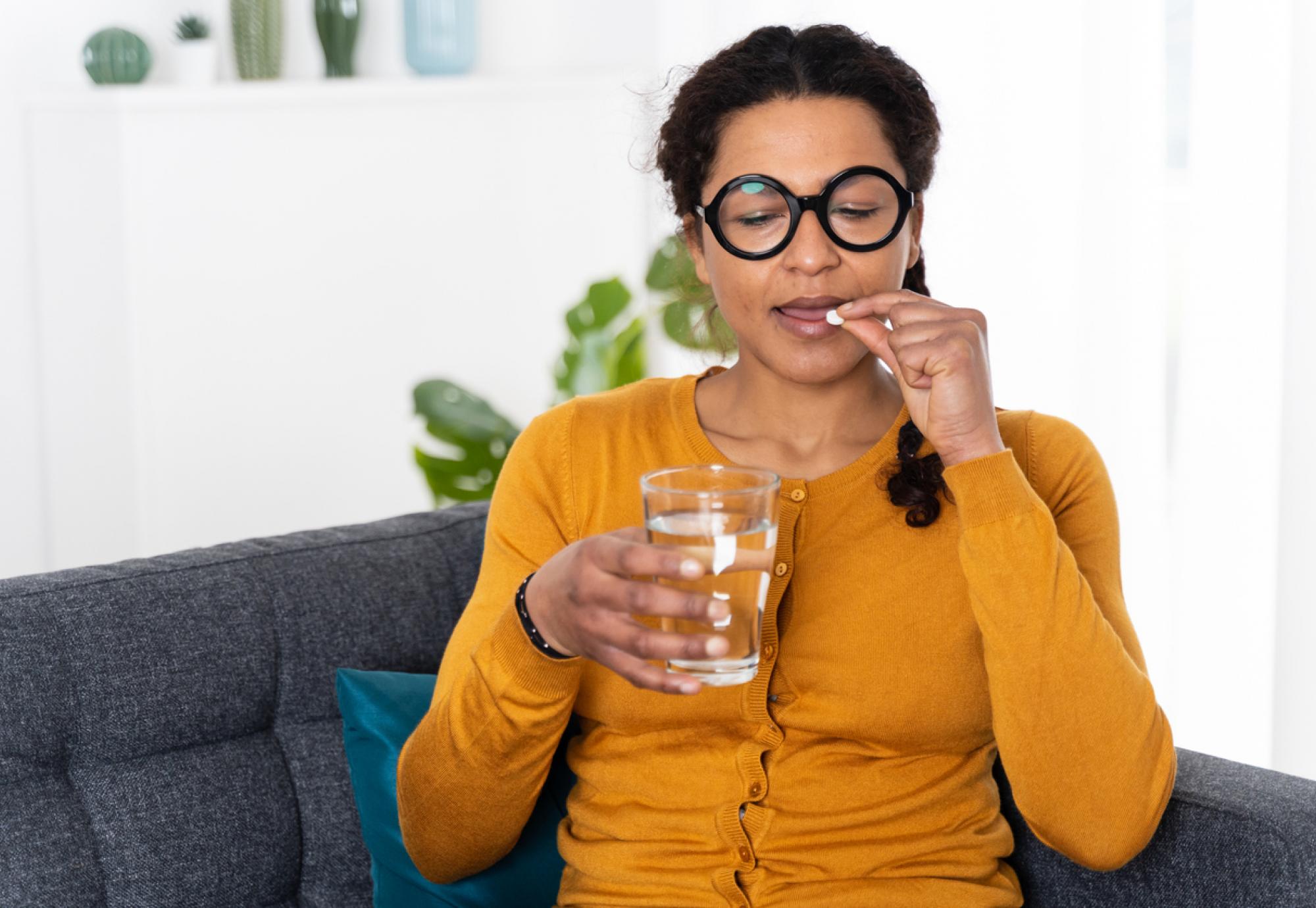 Woman taking tablet