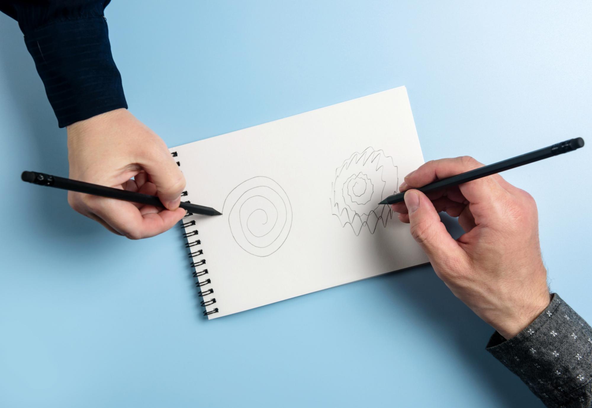 Two people drawing spirals