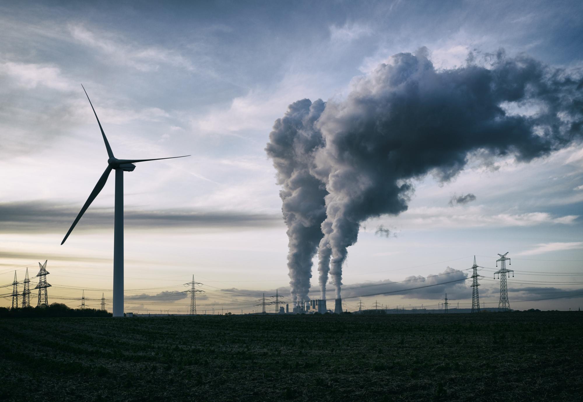 Wind turbine next to power plant