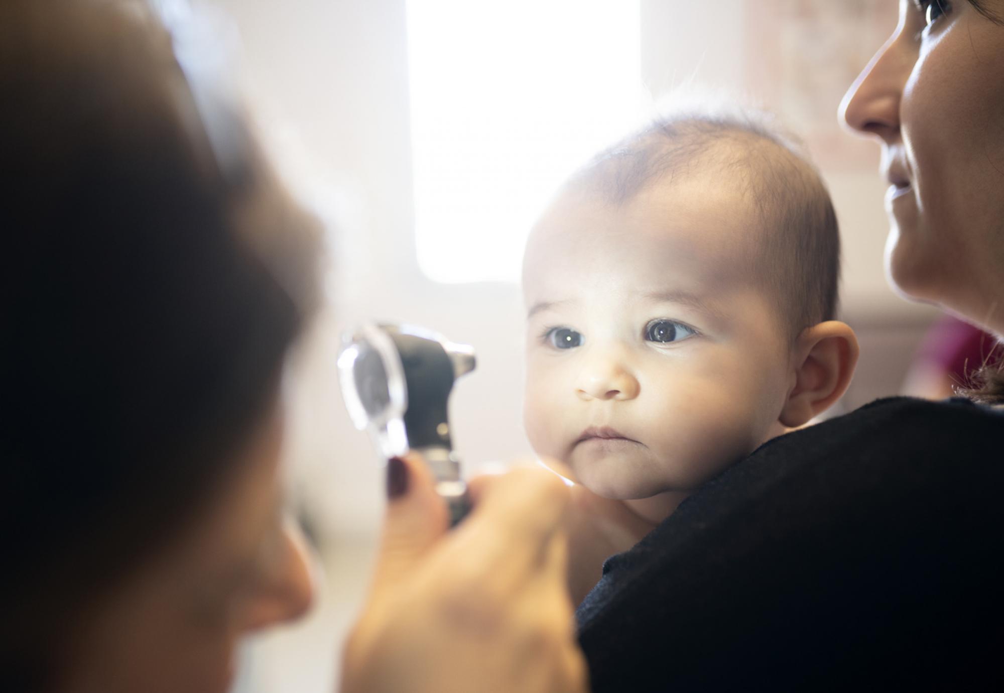 Doctor examining a baby's eye