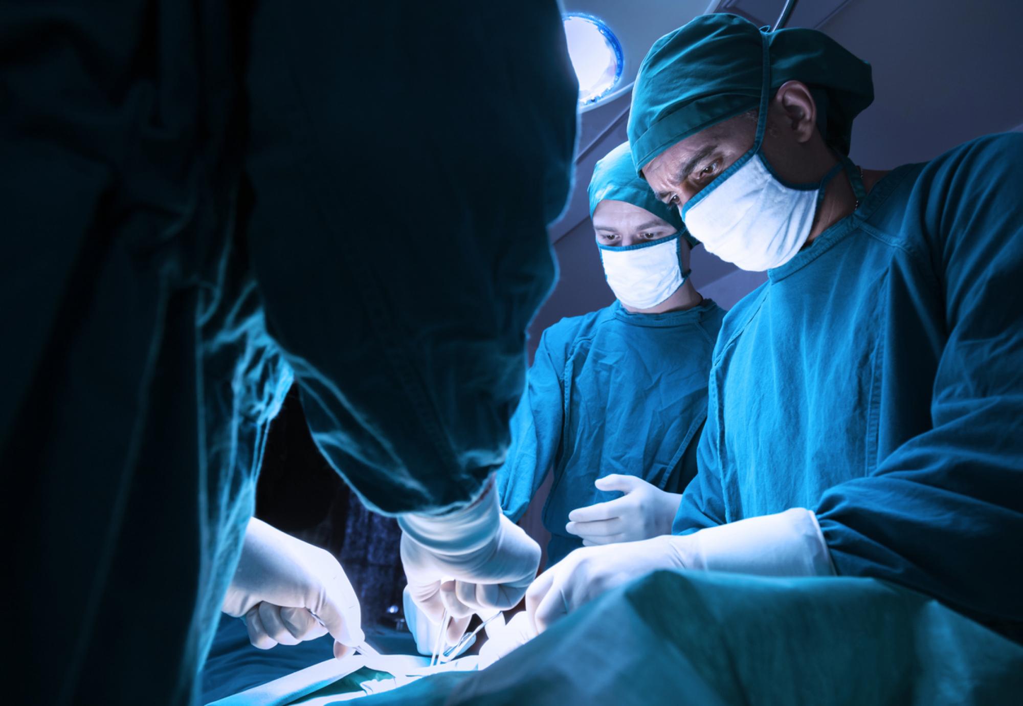 Surgeons operating on patient