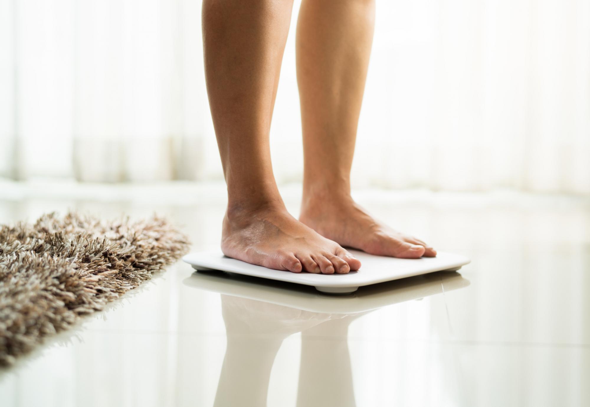 Woman standing on scales