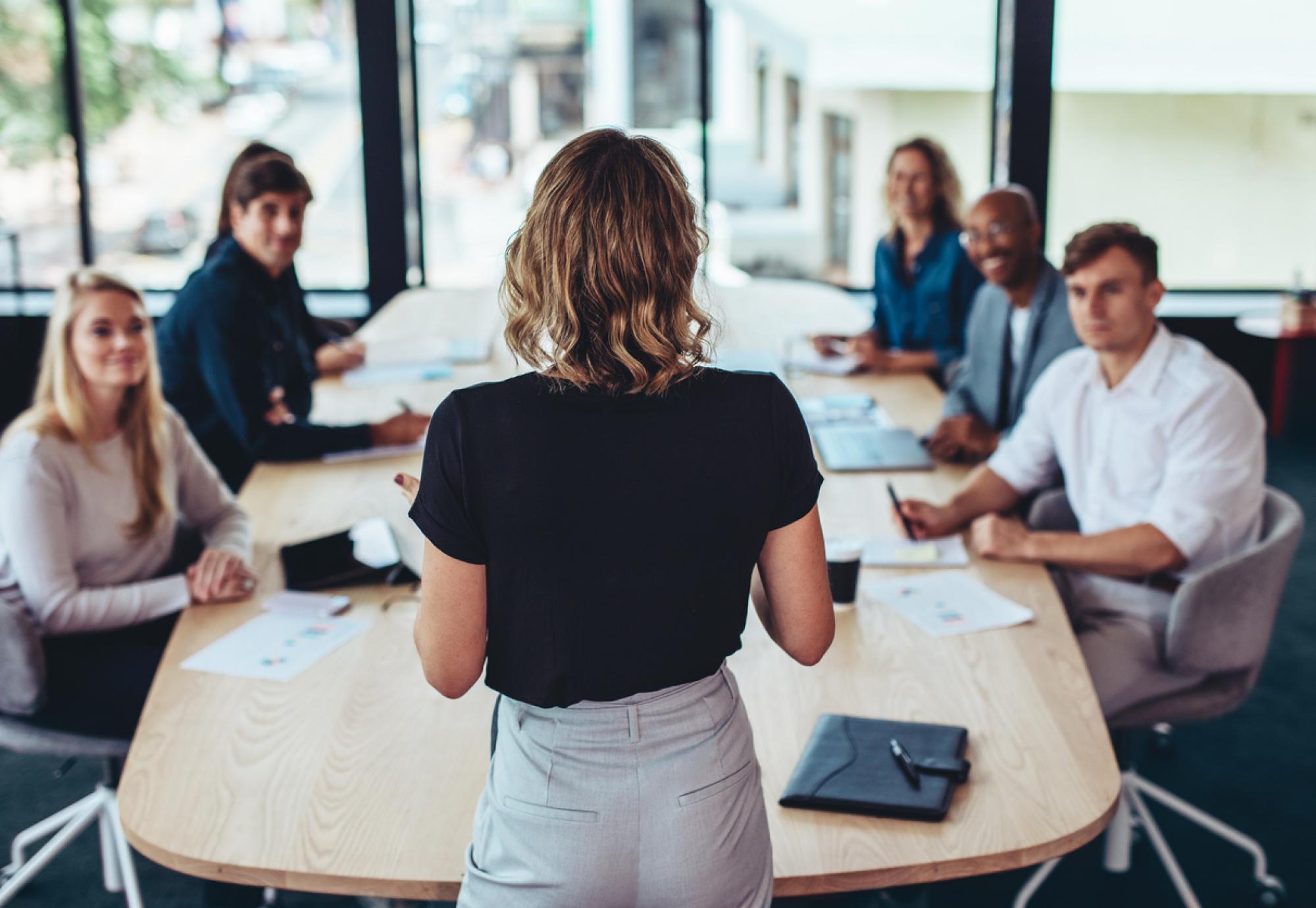 Woman addressing business meeting