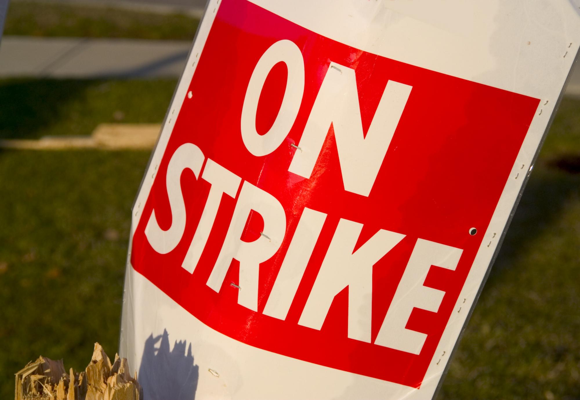 Red and white 'On Strike' sign