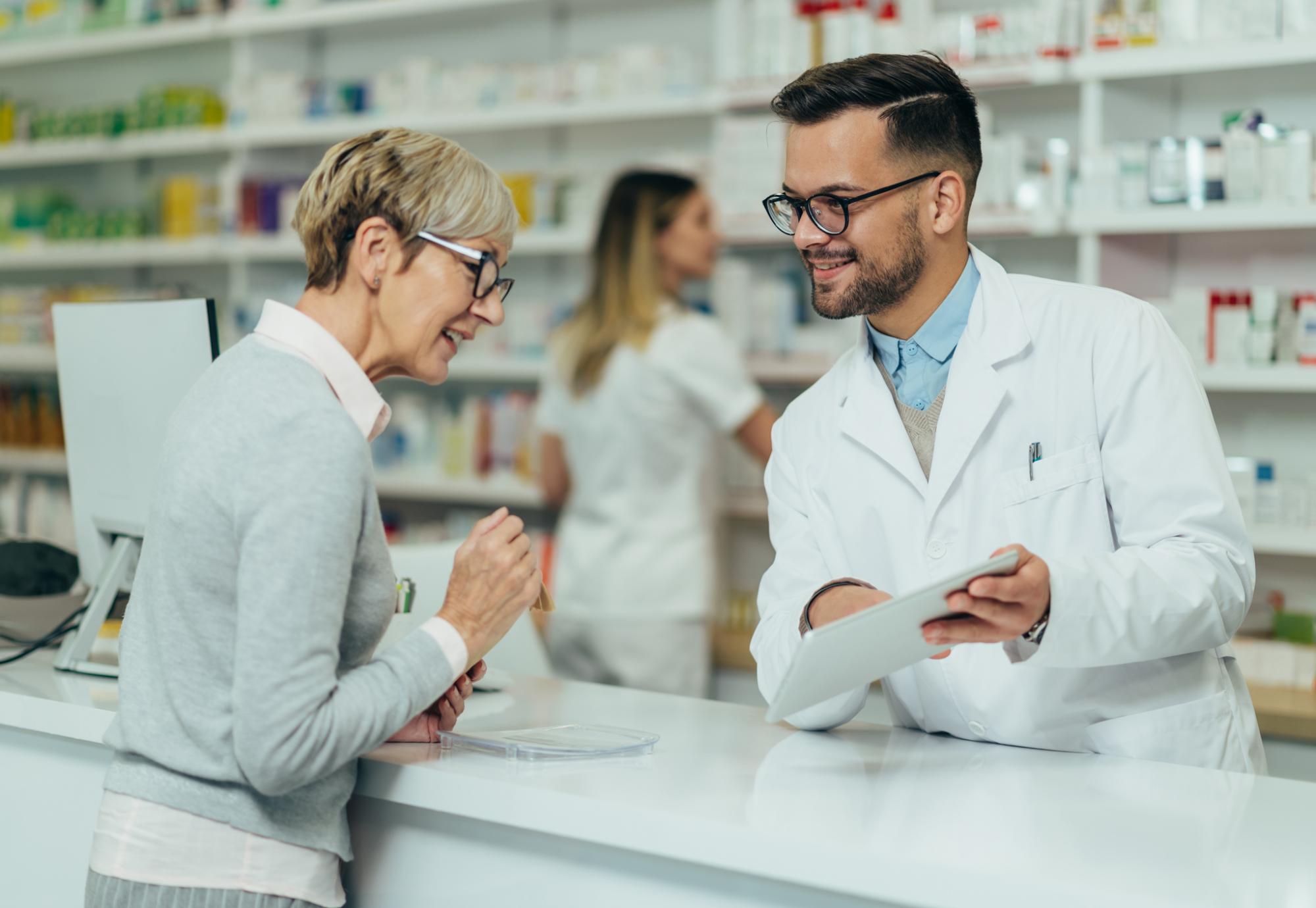 Pharmacist talking to woman