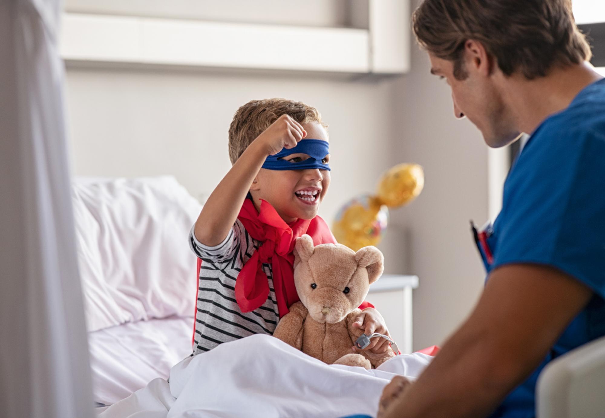 Child dressed as a superhero in hospital
