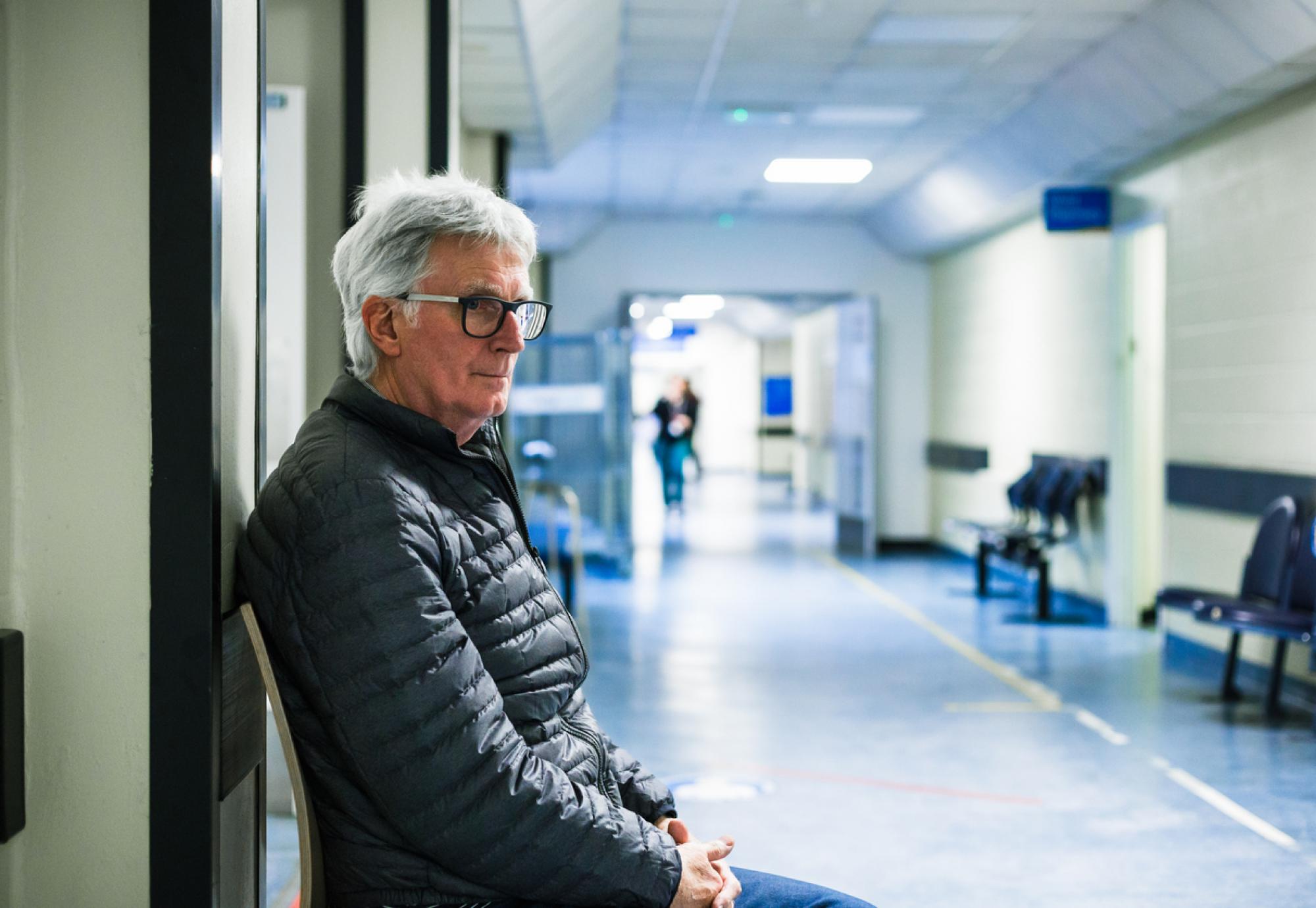 Man waiting in hospital corridor