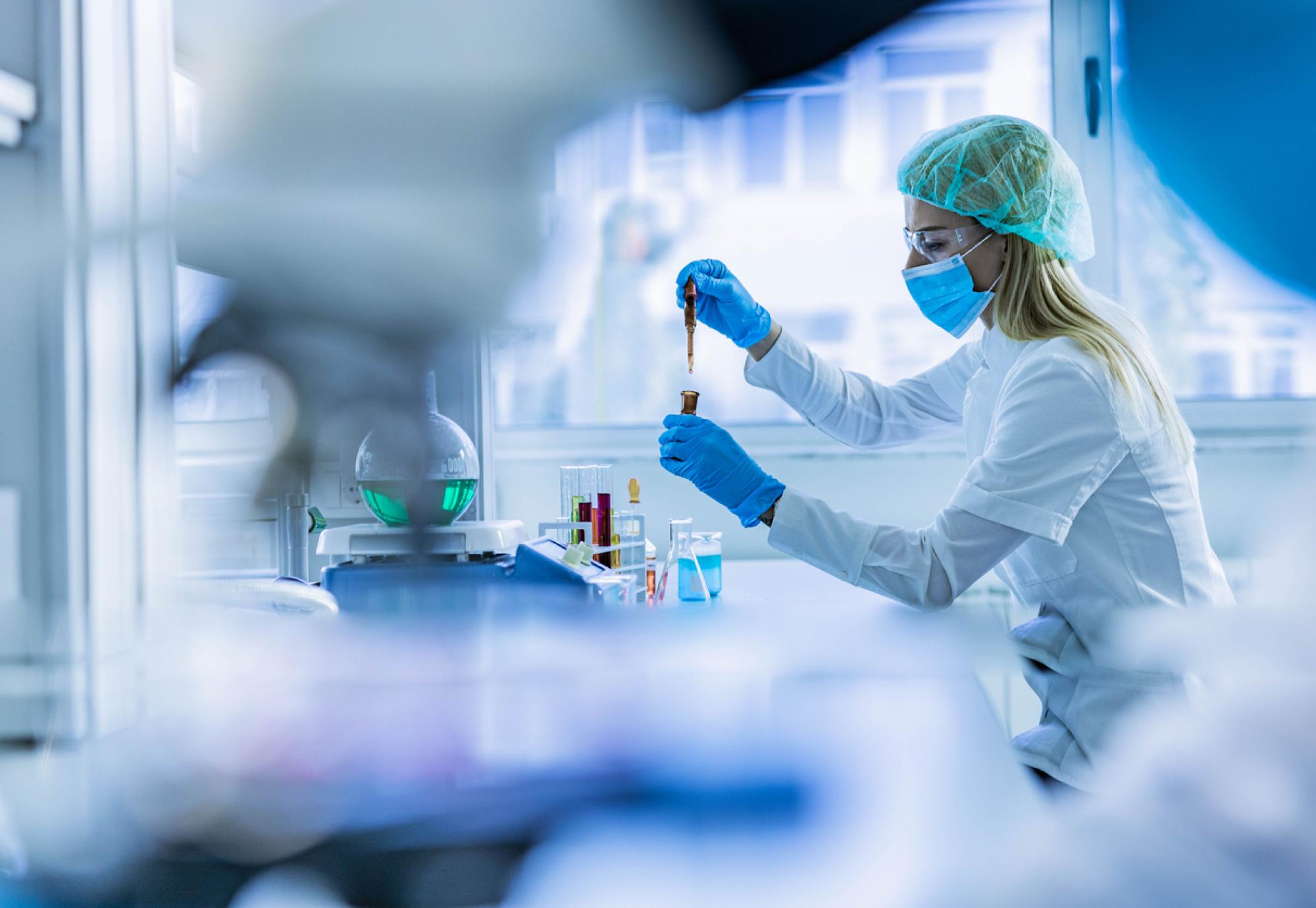 Female scientist examining toxic liquid in laboratory