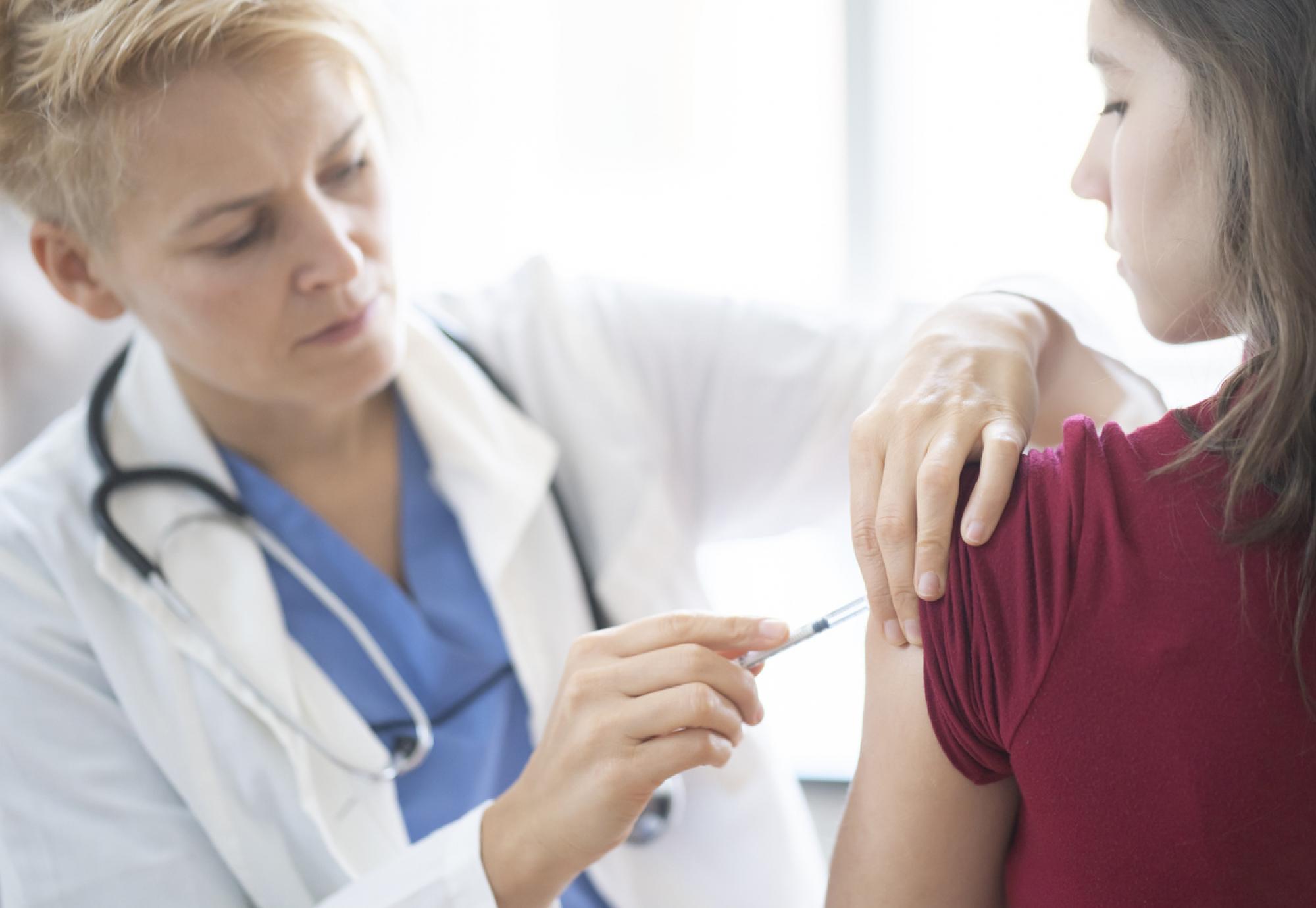 Teenage girl getting vaccinated