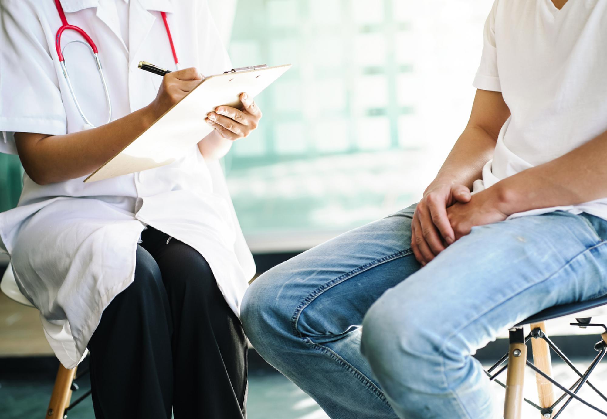 Female doctor asking questions to prostate cancer patient