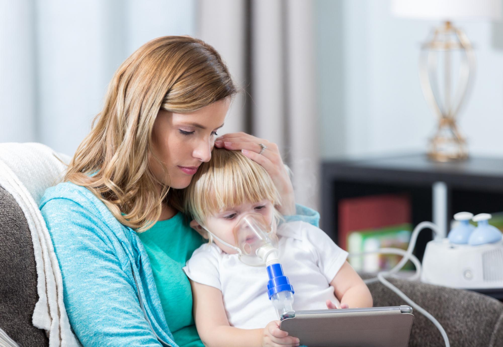 Young girl with cystic fibrosis receives breathing treatment