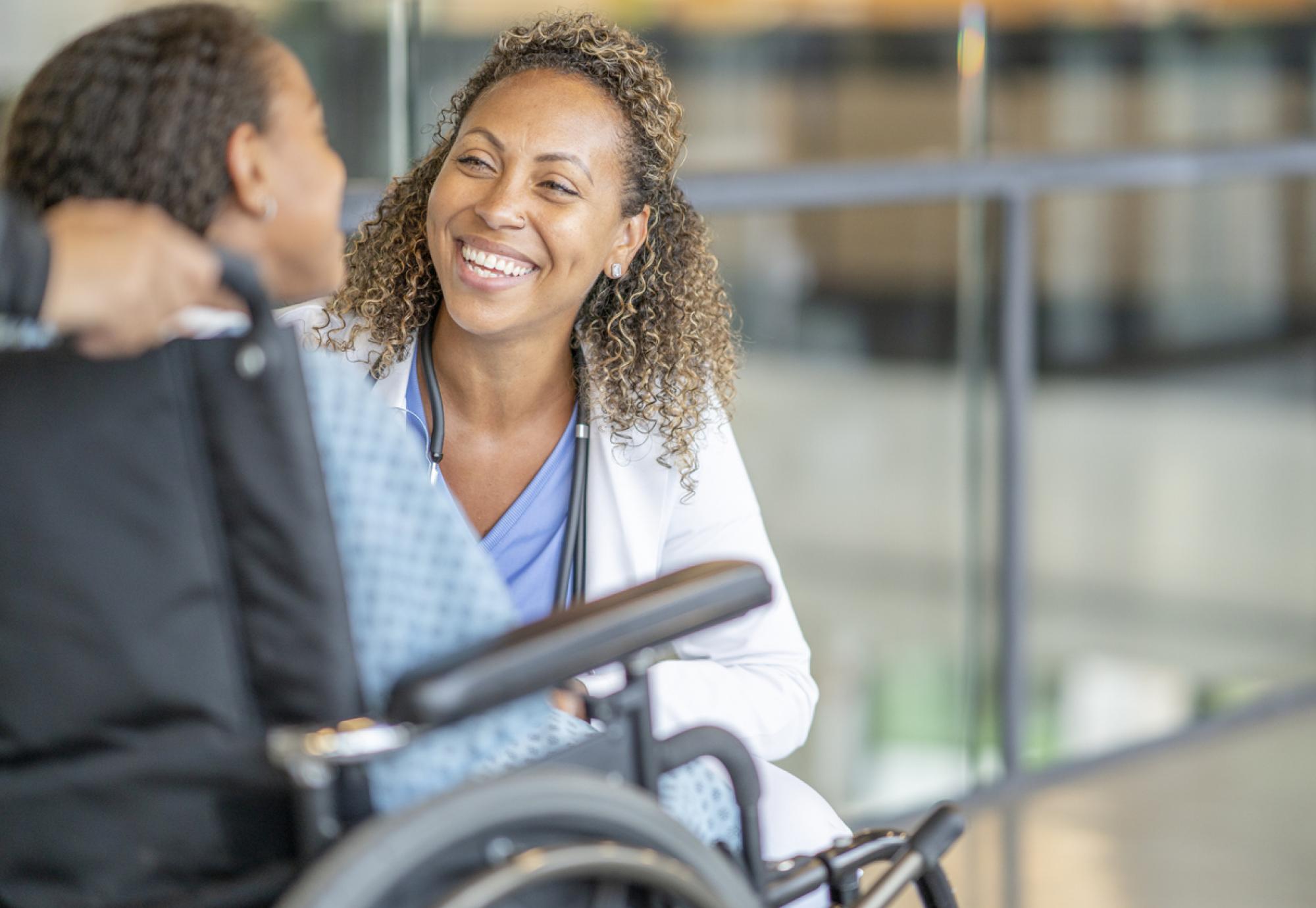 Young patient in a wheelchair with health professional