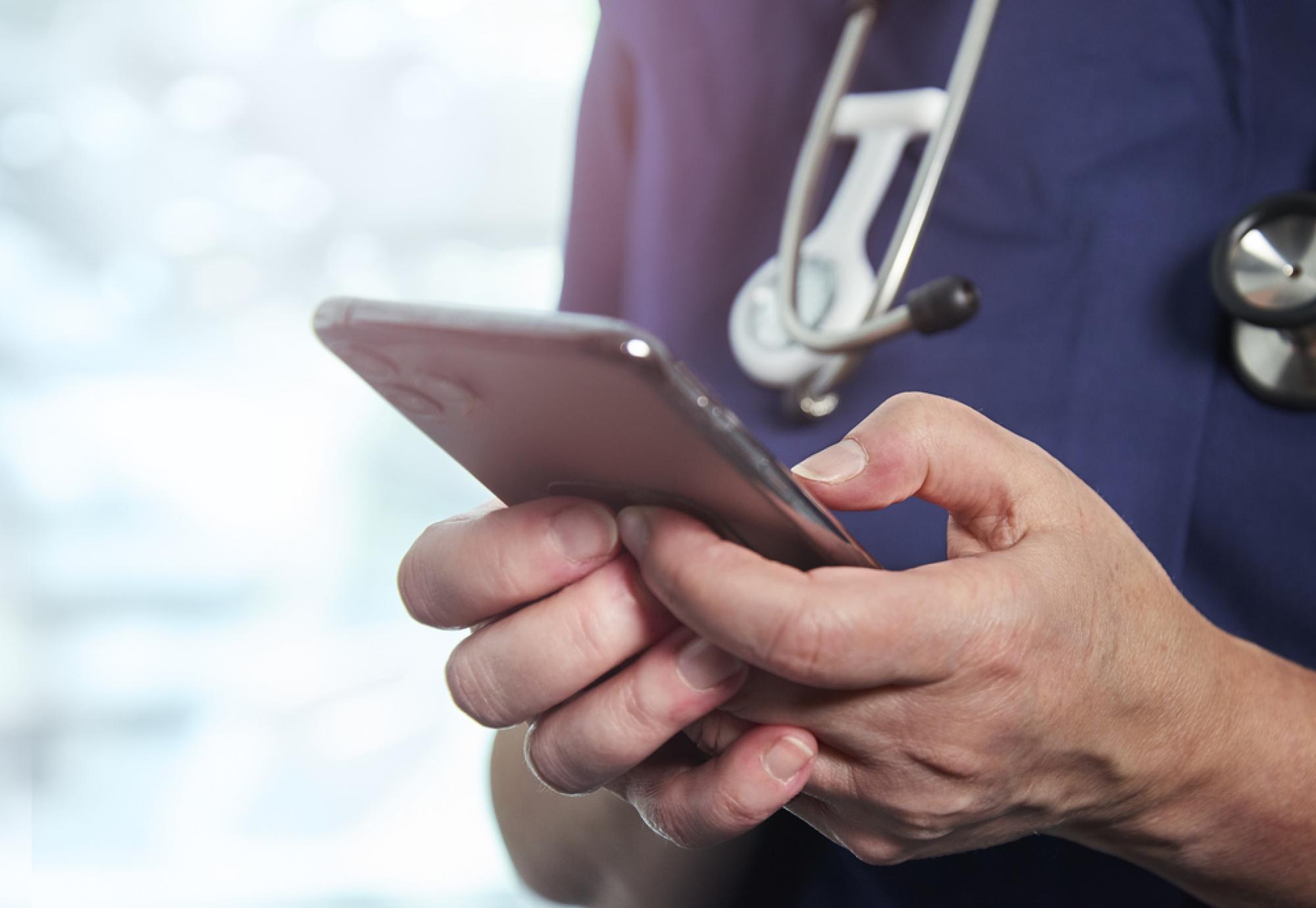 health professional holding phone