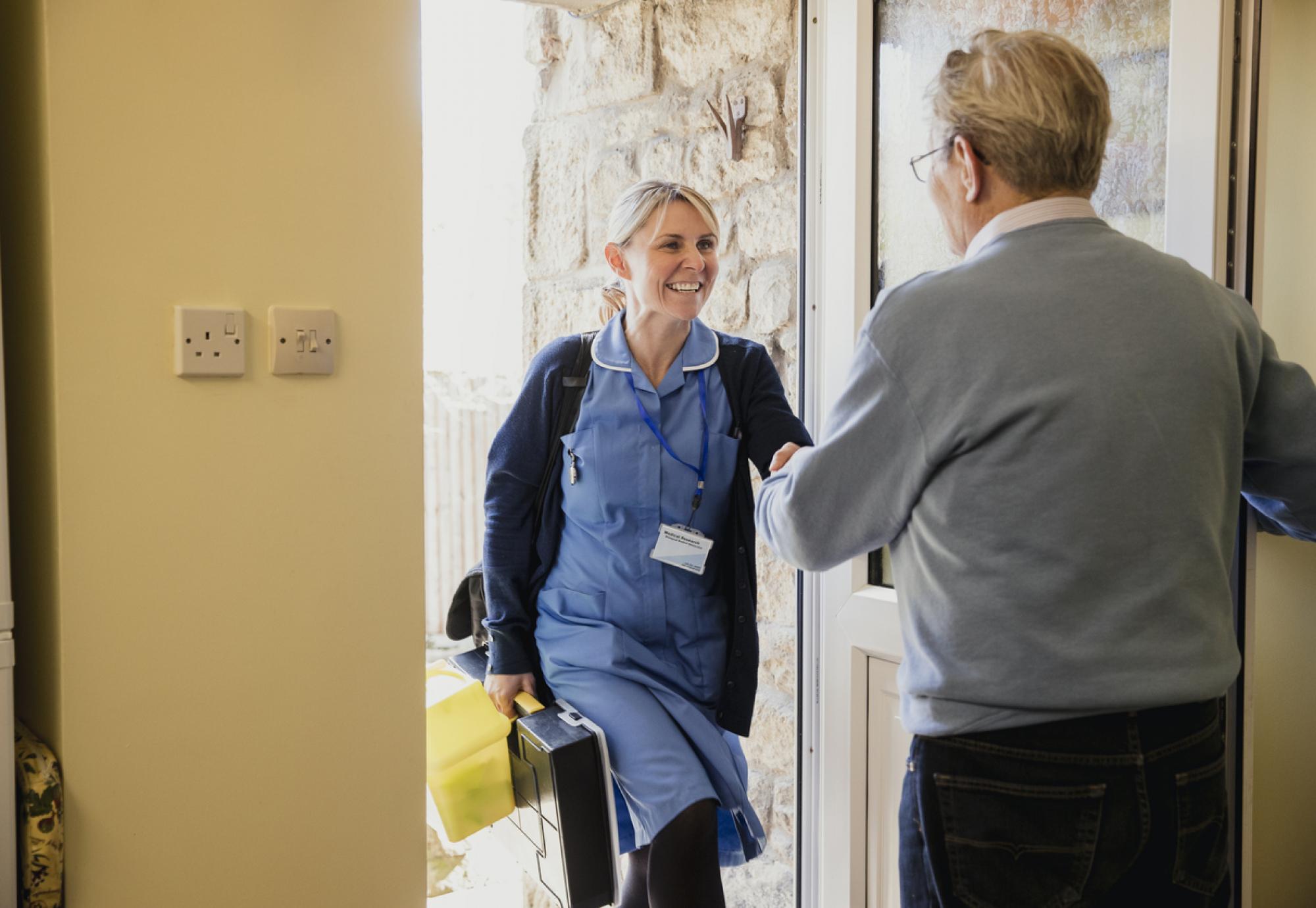 Health professional visiting patient at their home