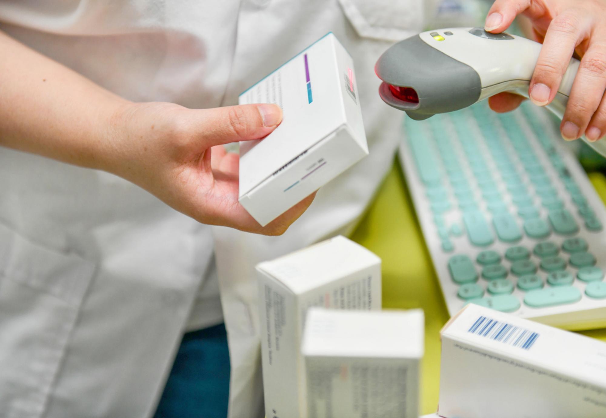 Pharmacist scanning barcode of medicine drug