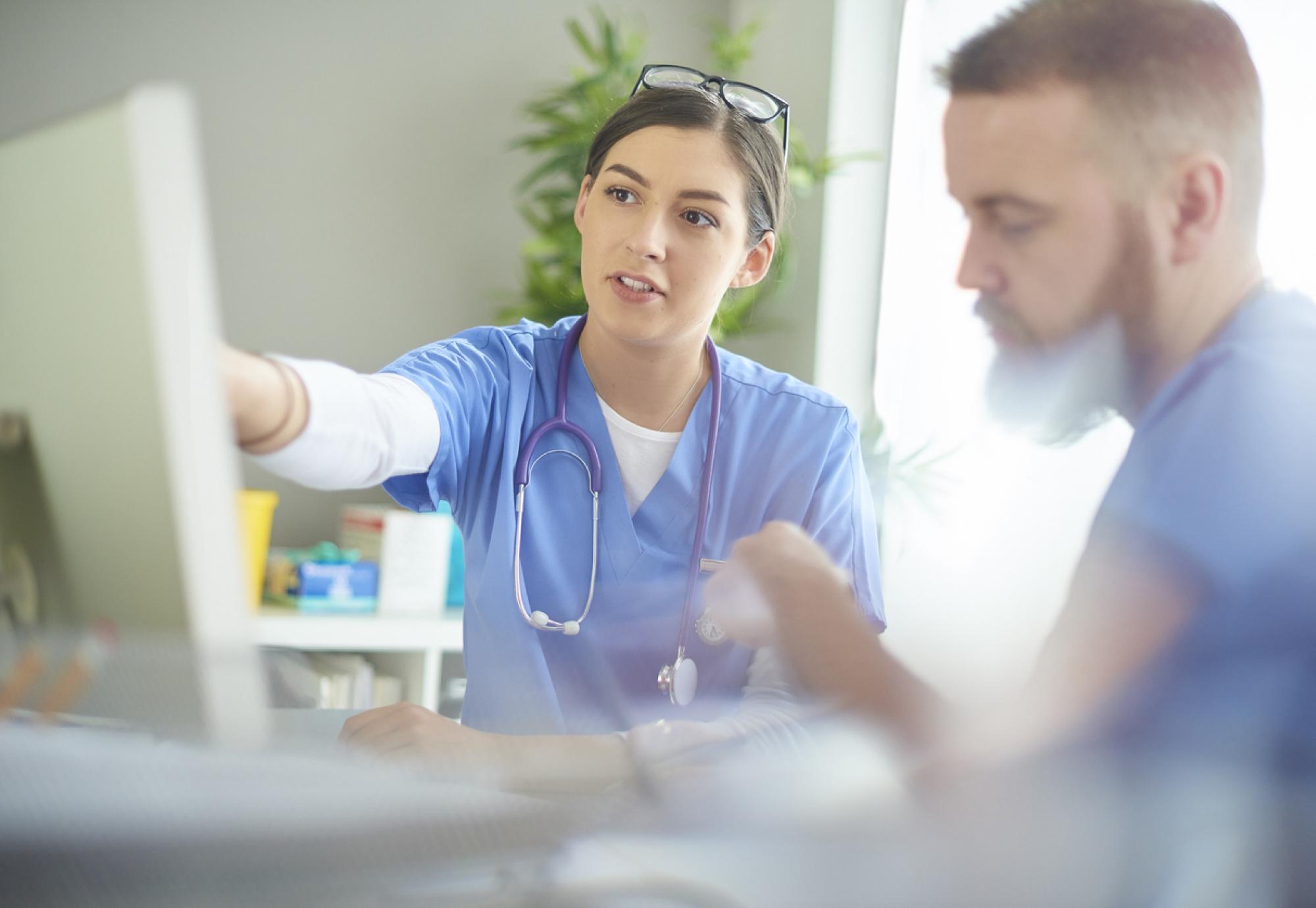 Medical professionals discussing notes