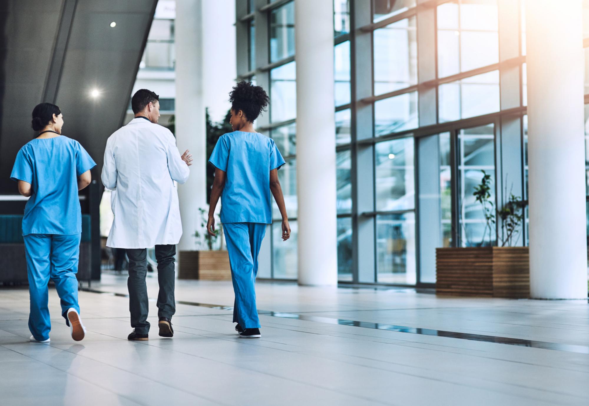 Clinicians walking through hospital