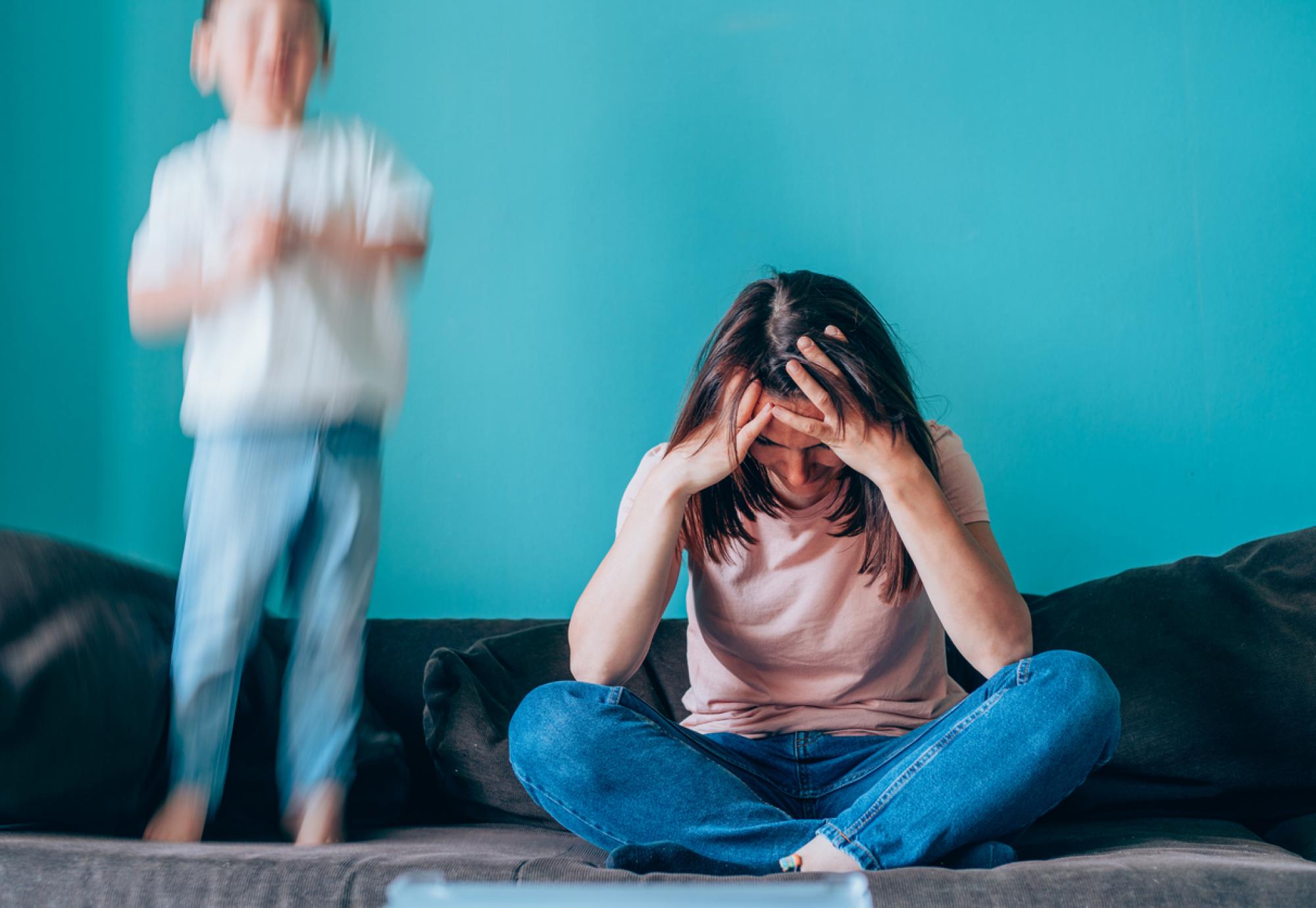 Stressed mother having problem with noisy son