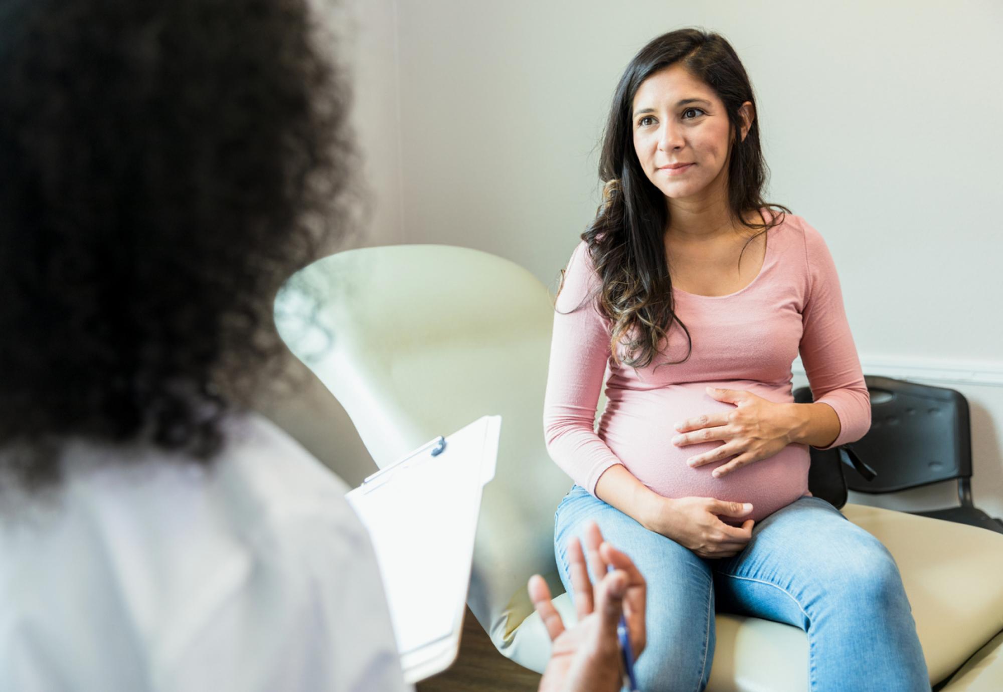 Pregnant woman and doctor