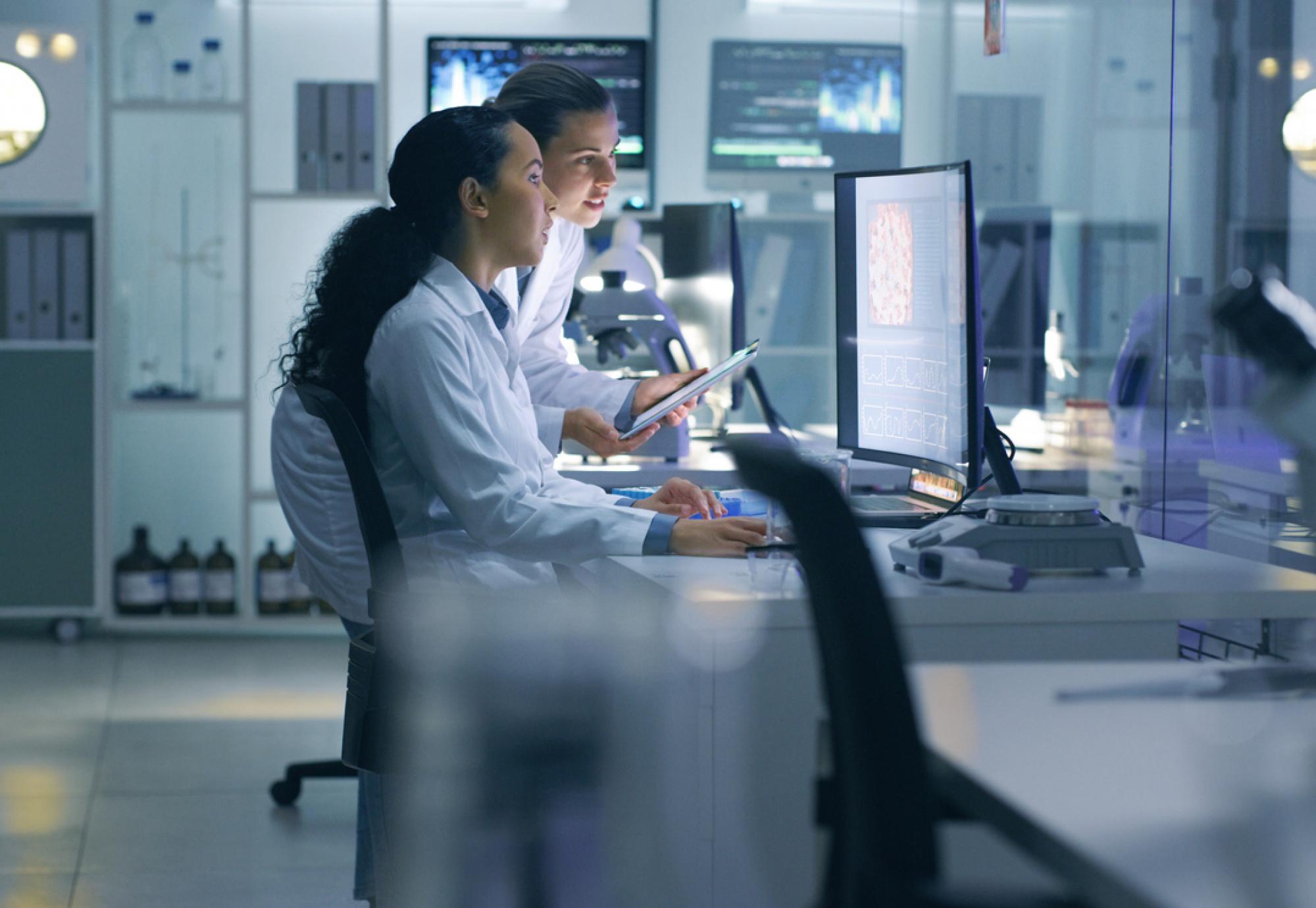 Scientists looking at a computer in a laboratory