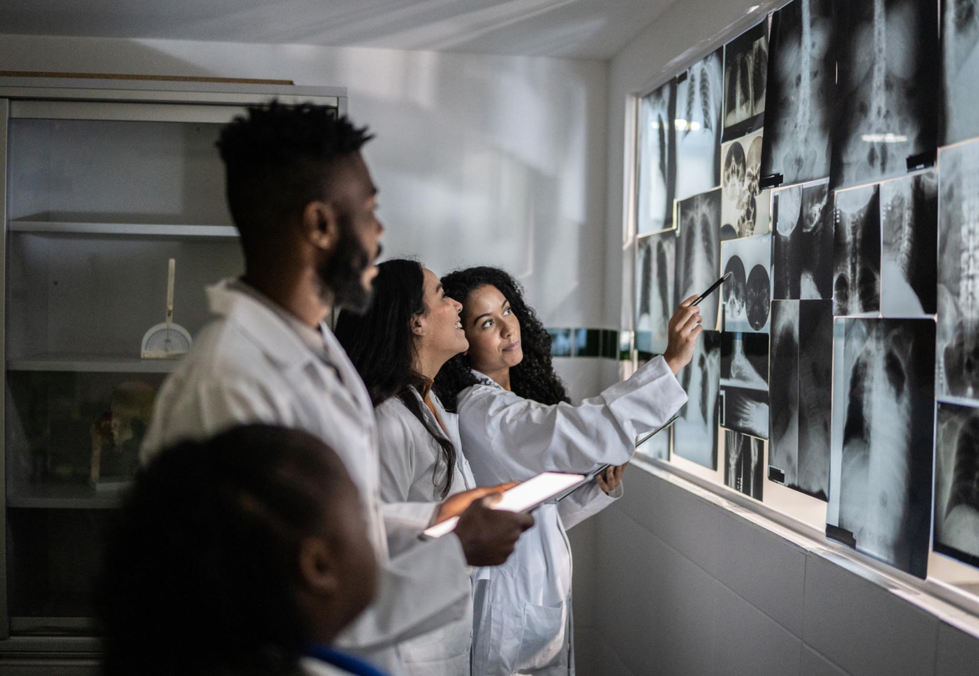 Radiographers analysing cancer scans