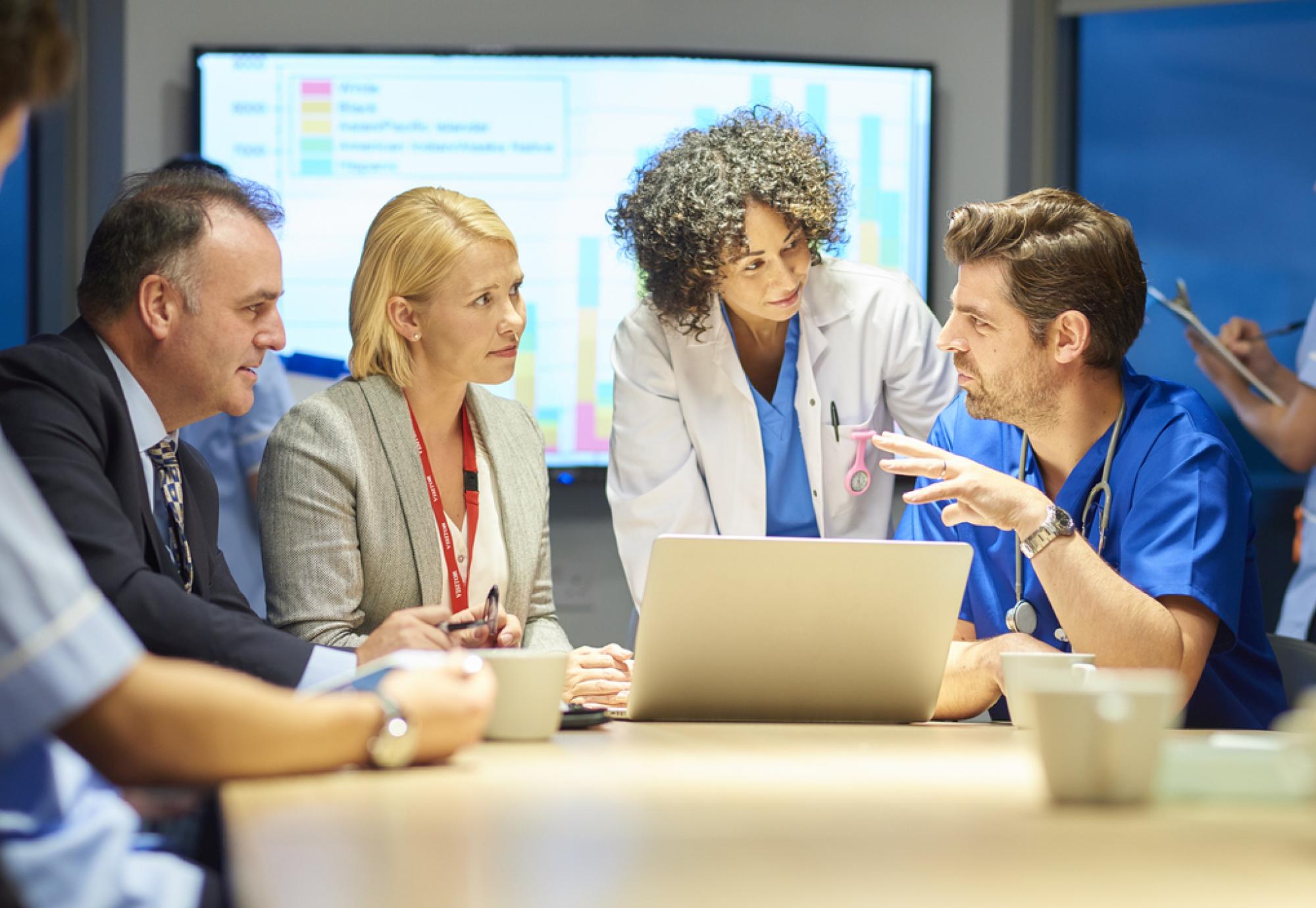 Meeting of healthcare professionals depicting the partnership between the NHS and local council to improve employment prospects