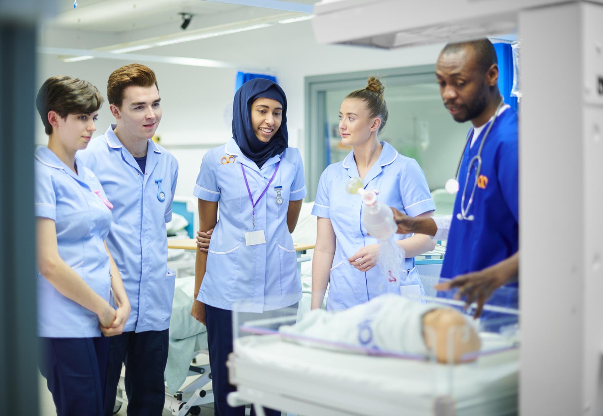 NHS professionals speaking to paediatric nurse