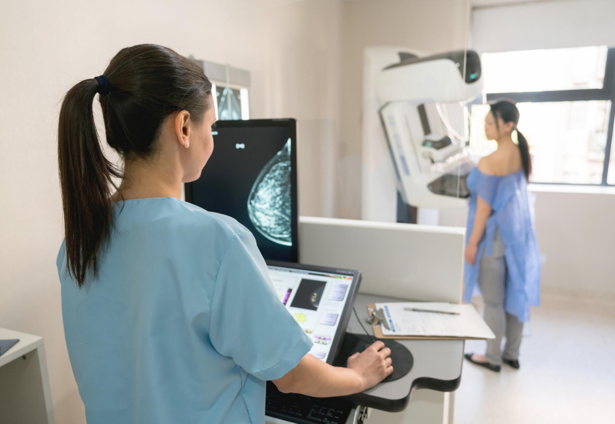 Woman undergoing a mammogram depicting cancer diagnosis