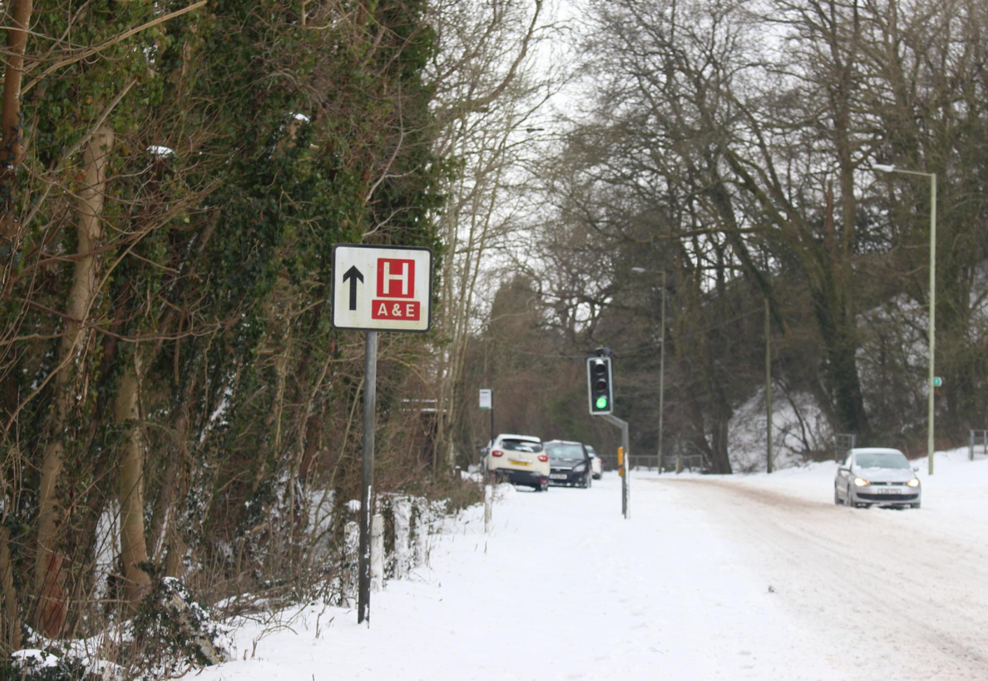 Hospital sign on a snowy road depicting NHS winter pressures