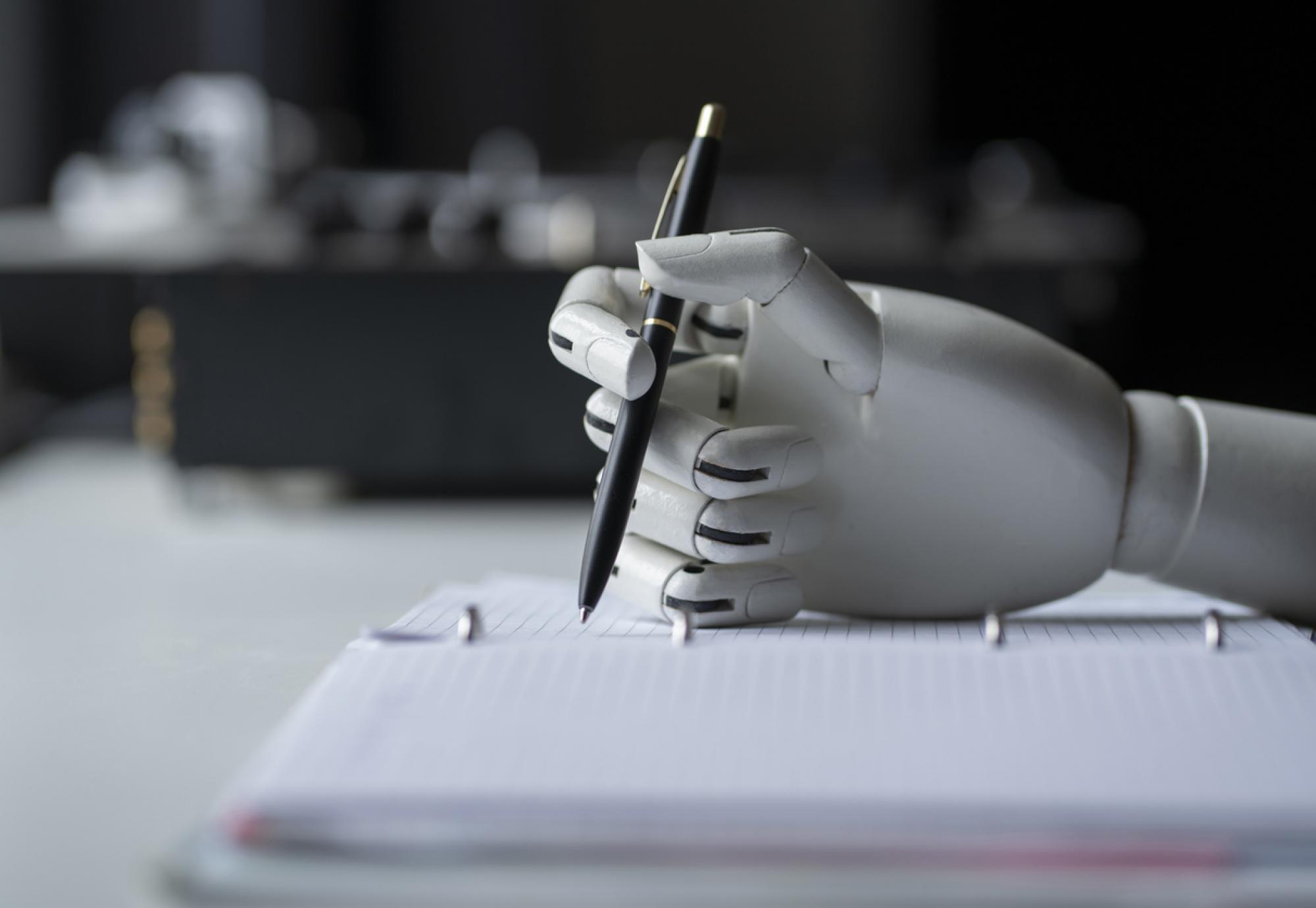 Robot holding a pen depicting AI tools in healthcare peer-reviewing grant applications