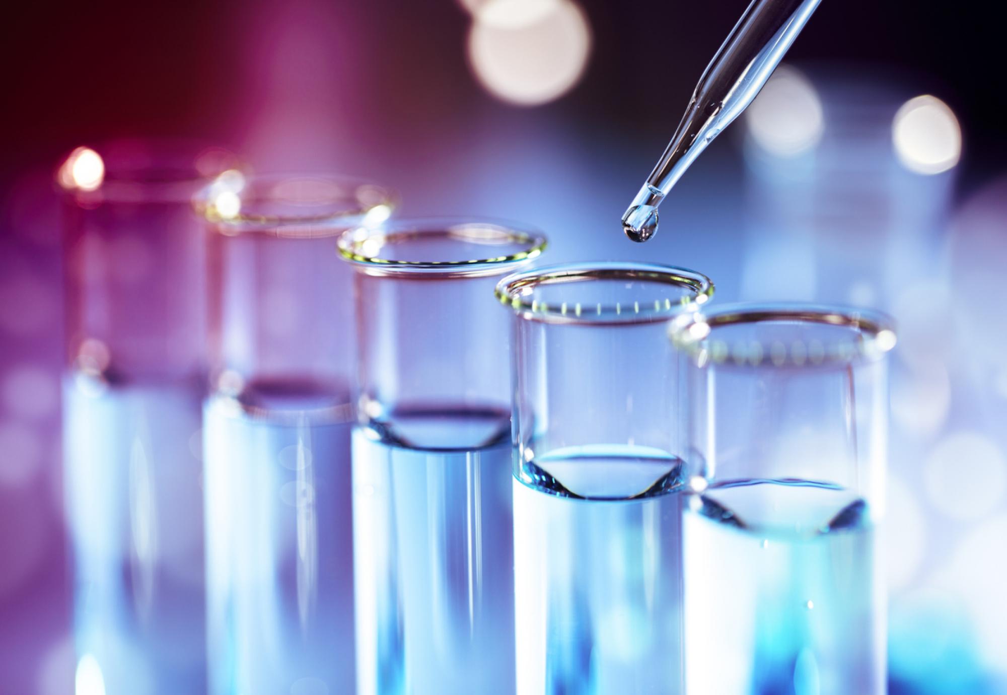 Science beakers in a line depicting cancer research