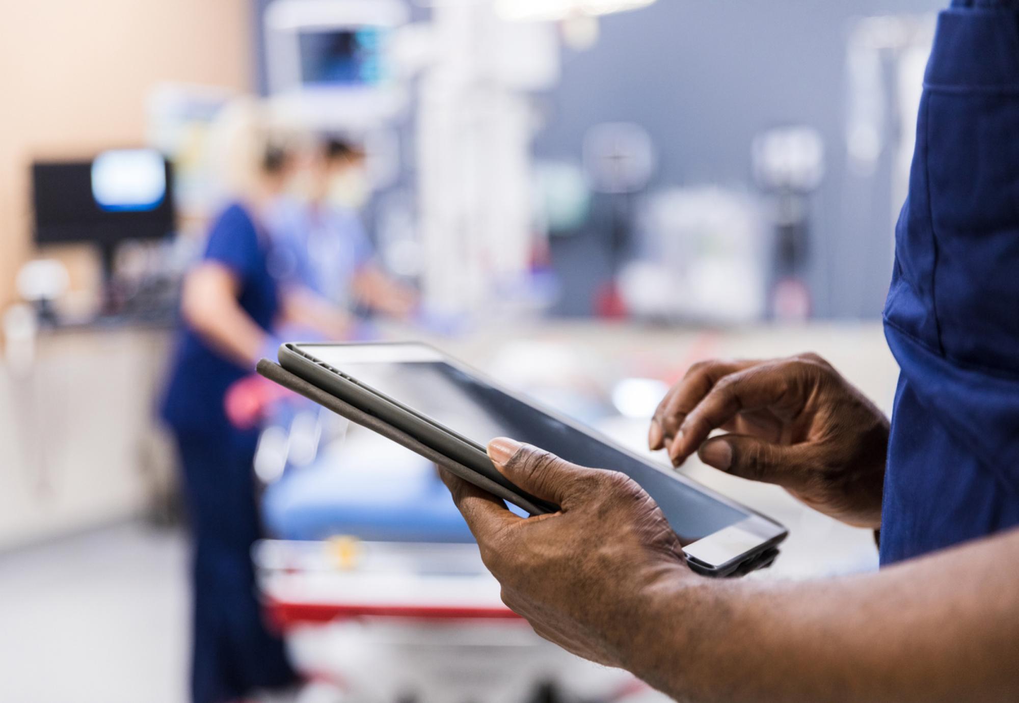 Health professional holding a tablet depicting digital transformation