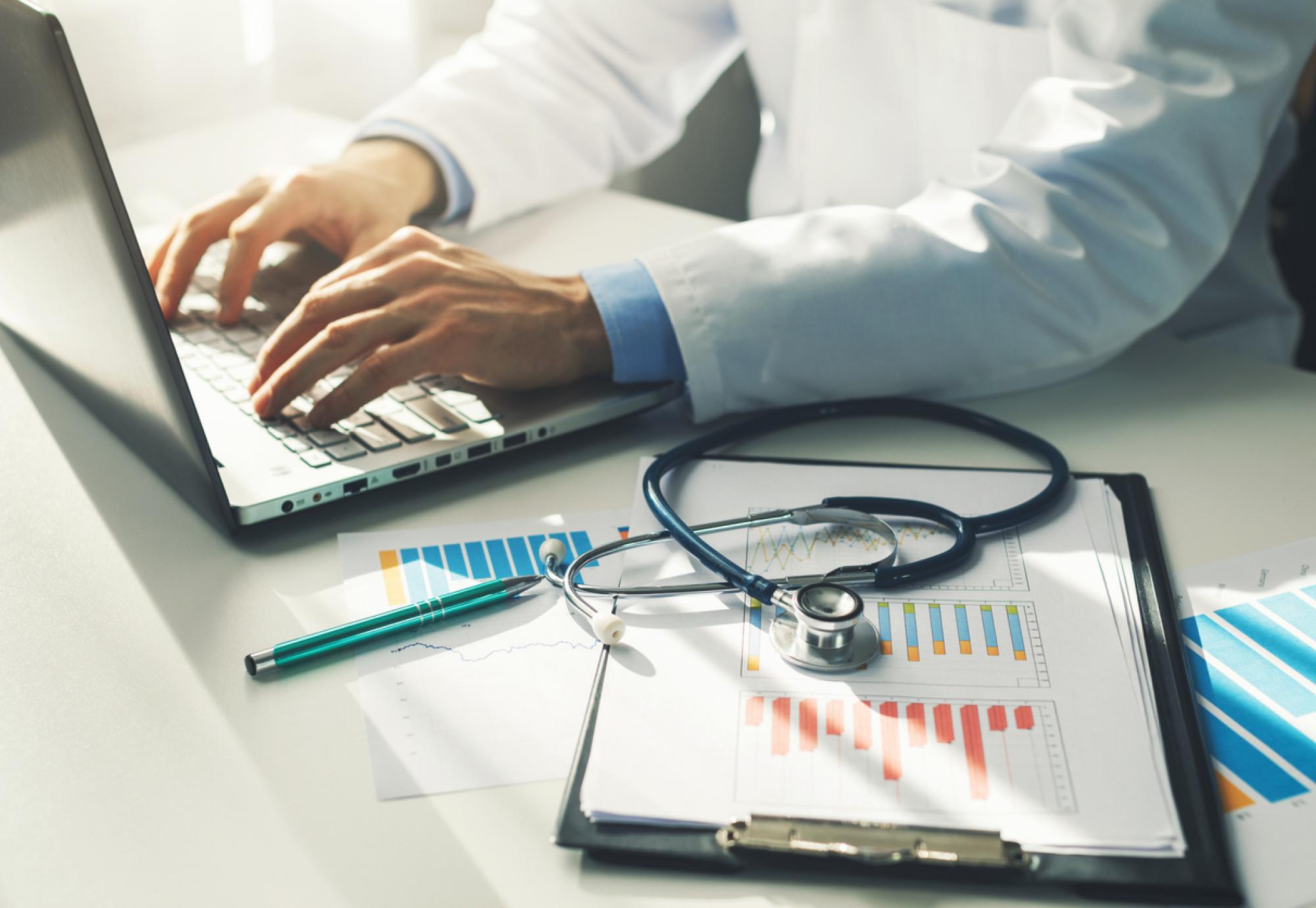 Doctor working with paperwork depicting the new equality, diversity and inclusion figures from the new workplace disability standard data