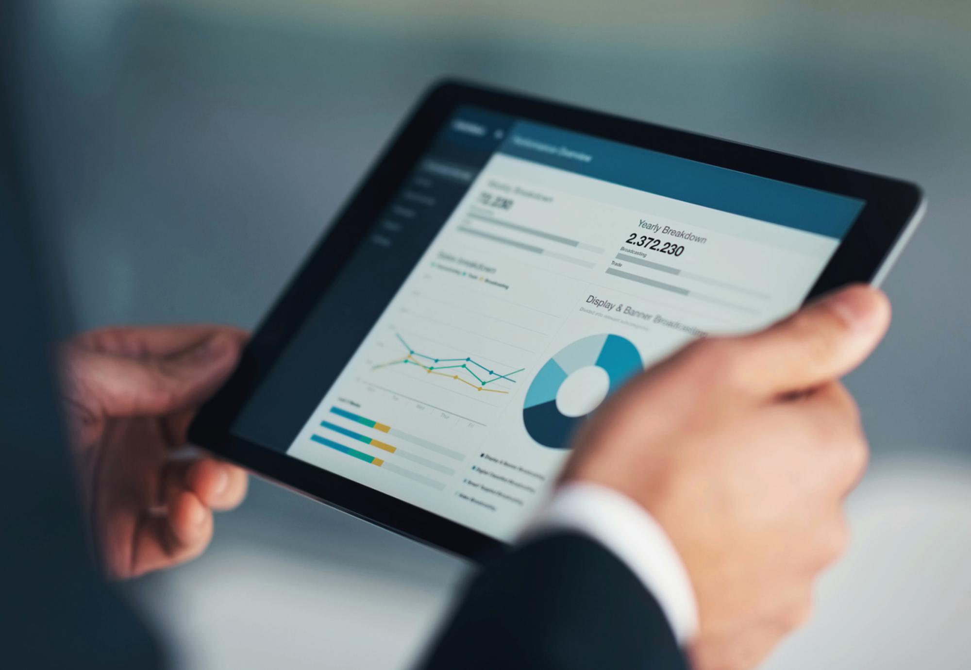 Man holding a digital tablet depicting the UK Health Security Agency's new infectious disease data dashboard