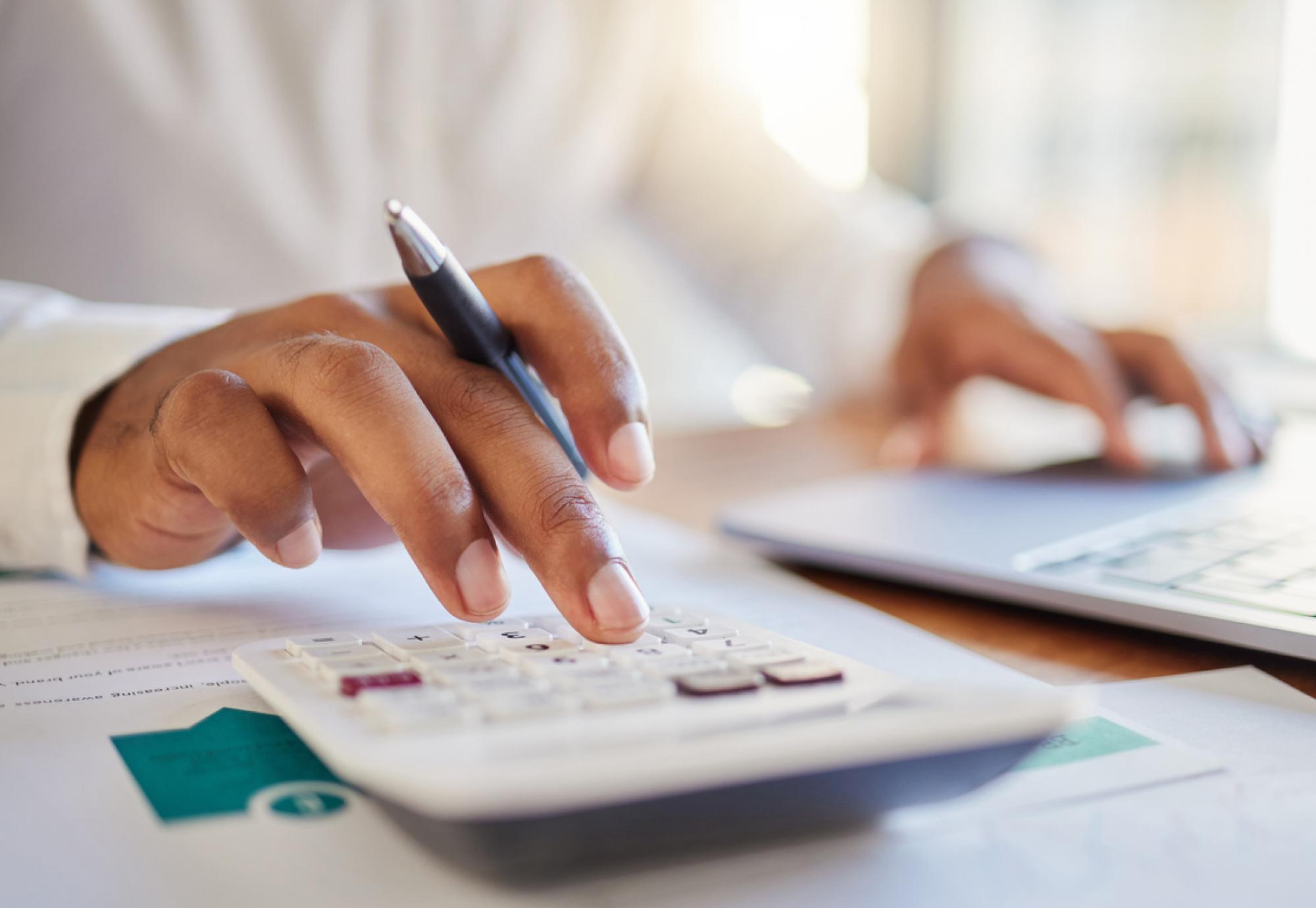 Person using a calculator depicting the Health Foundation's analysis that shows most people want extra funding for the NHS