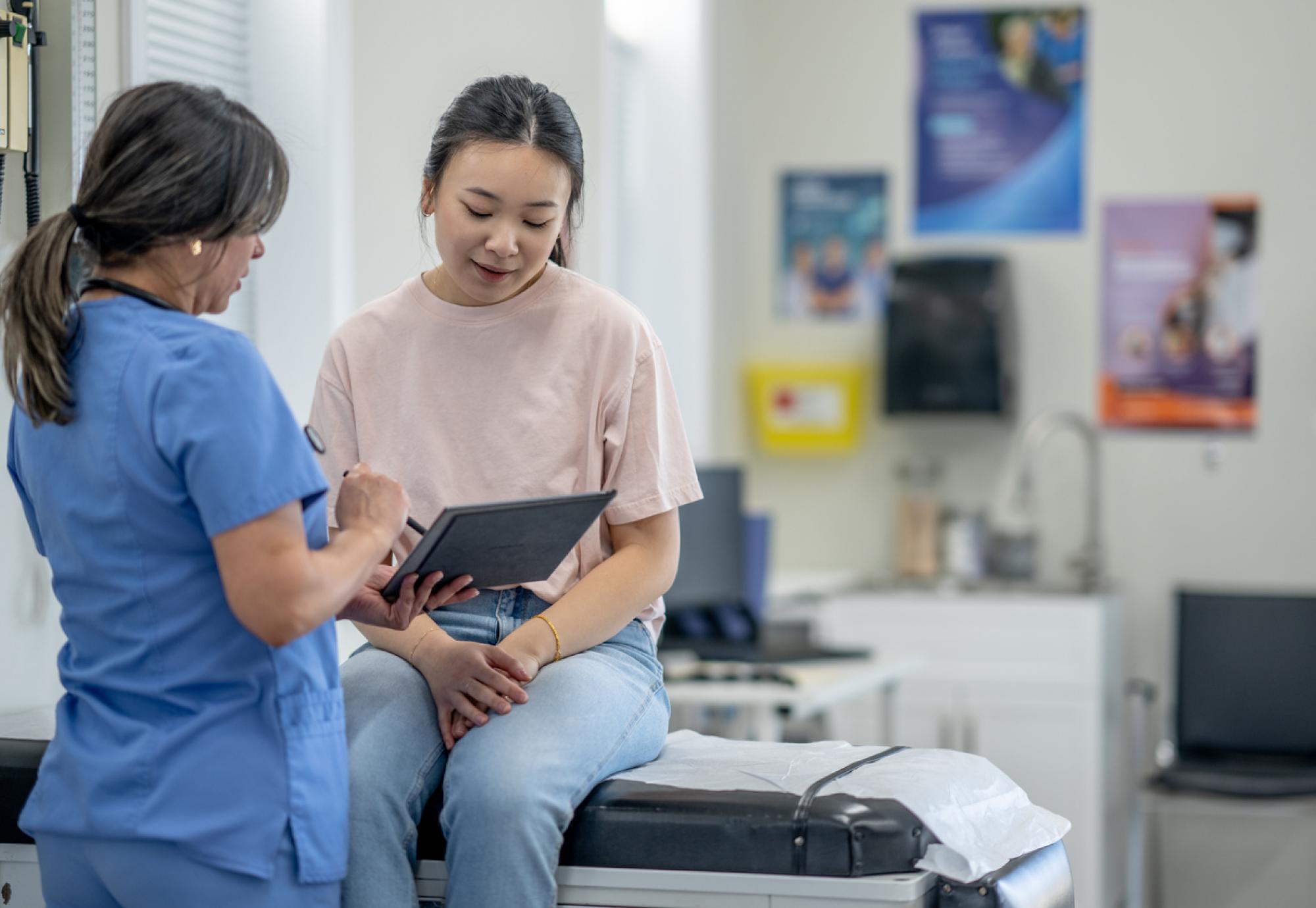 Nurse consulting a patient depicting a women's health appointment