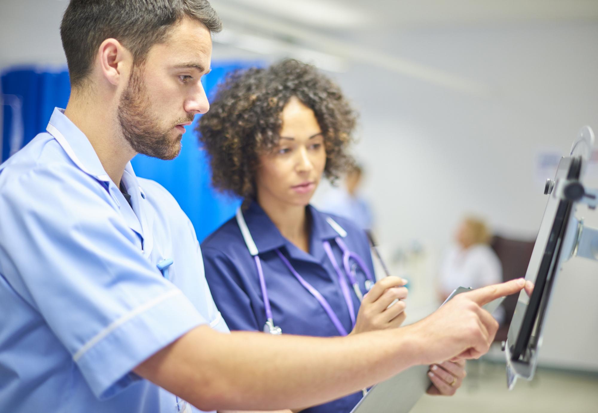 Image of NHS staff using a tablet depicting digital innovation across NHS Wales