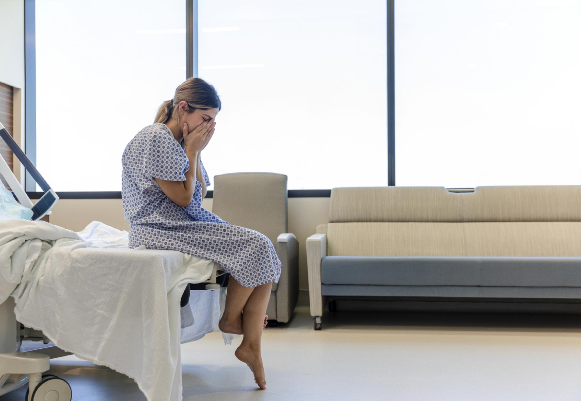 Patient sitting on a hospital bed depicting the NHS mental health crisis