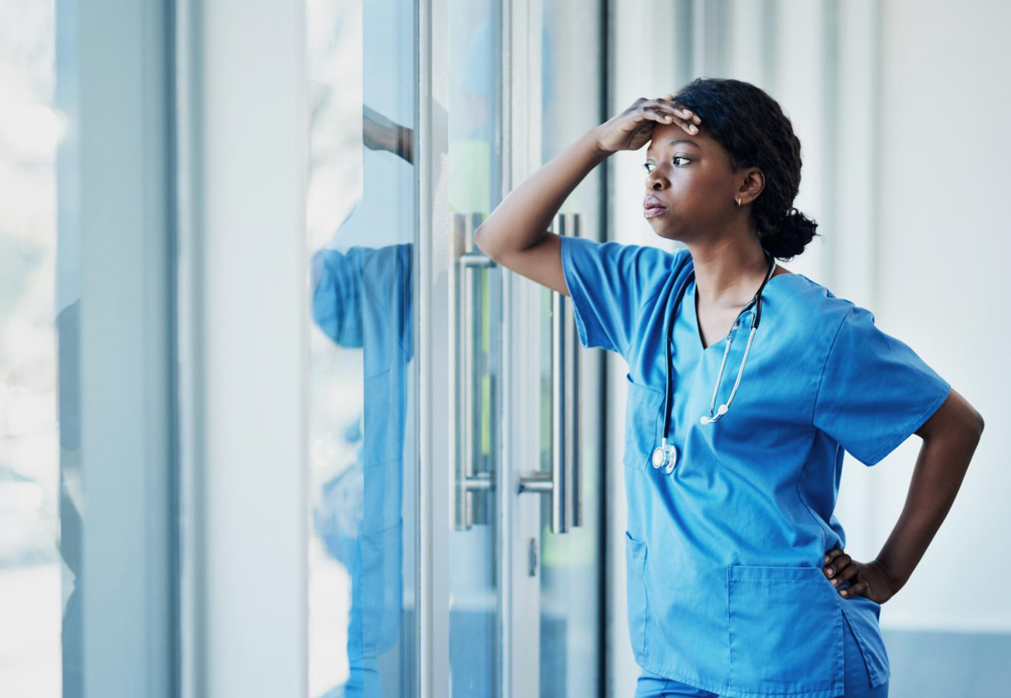 Stressed healthcare worker depicting the NHS recruitment and retention crisis