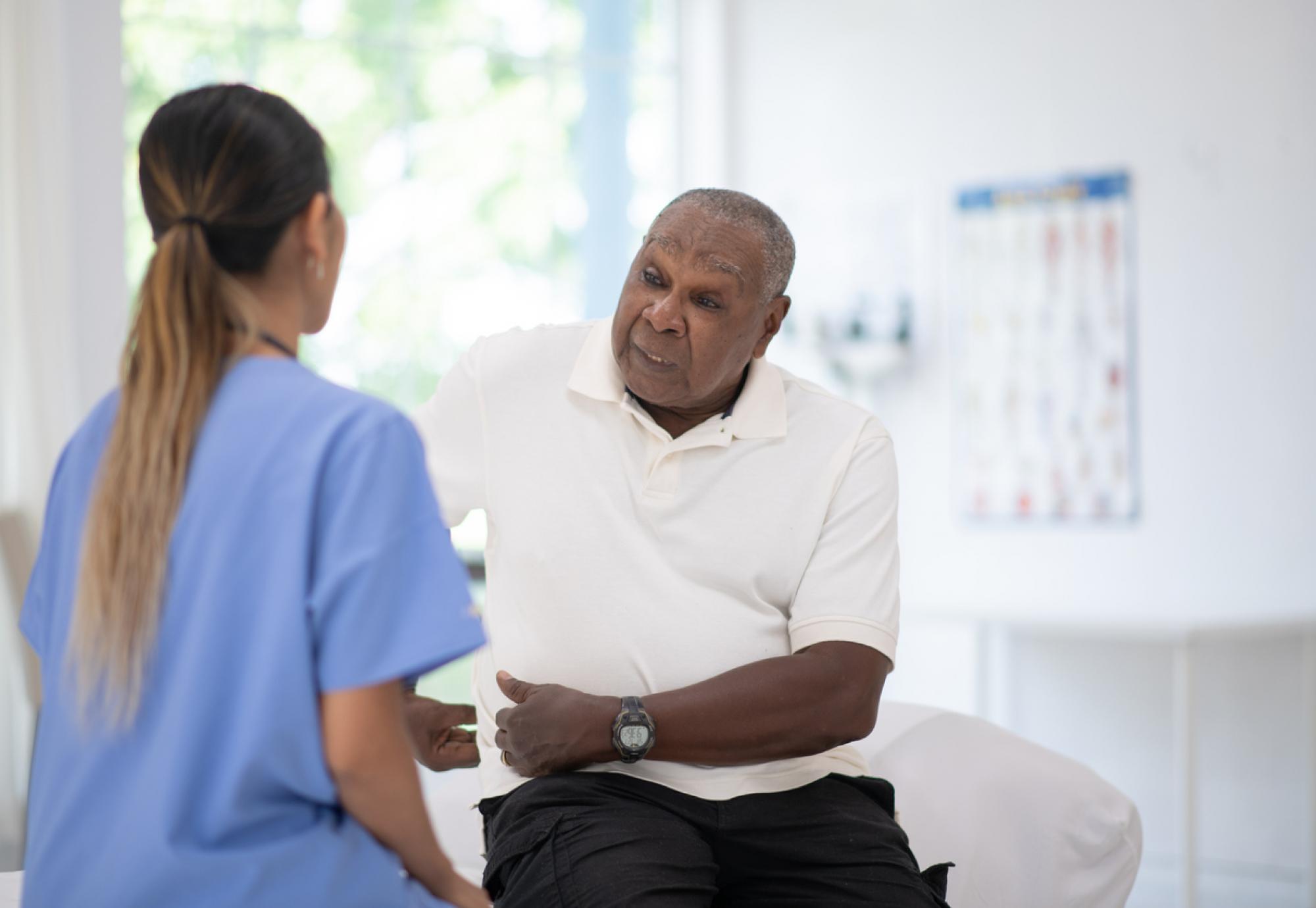 An Elderly Gentleman in His Doctors Office Receiving a Check-Up