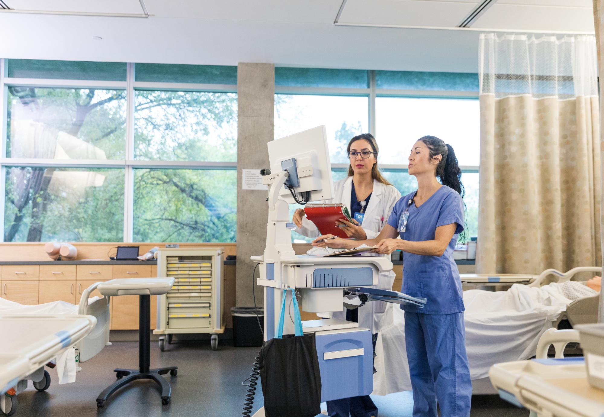 Doctors using a computer to access patient data