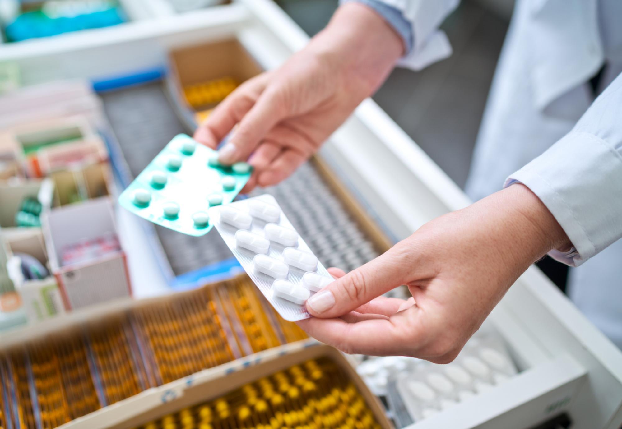 Female pharmacist holding medicines